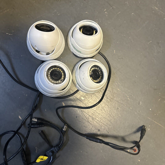 Set of four white analog CCTV dome security cameras with cables on gray surface for 1080P surveillance system