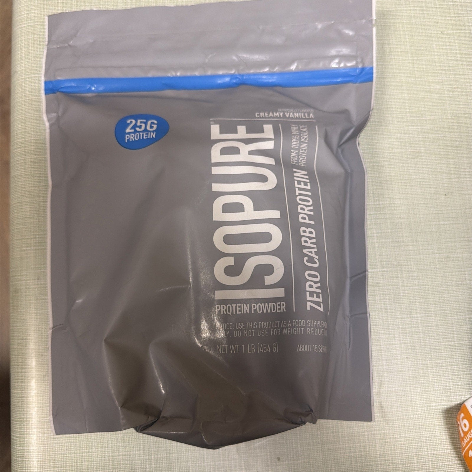Gray resealable pouch of Isopure zero carb protein powder in creamy vanilla flavor featuring 25 grams of protein per serving and product details on the front.