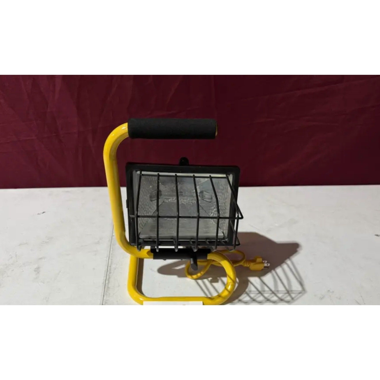 Heavy duty work light model L 18 with yellow frame and protective metal cage for workshop or garage use