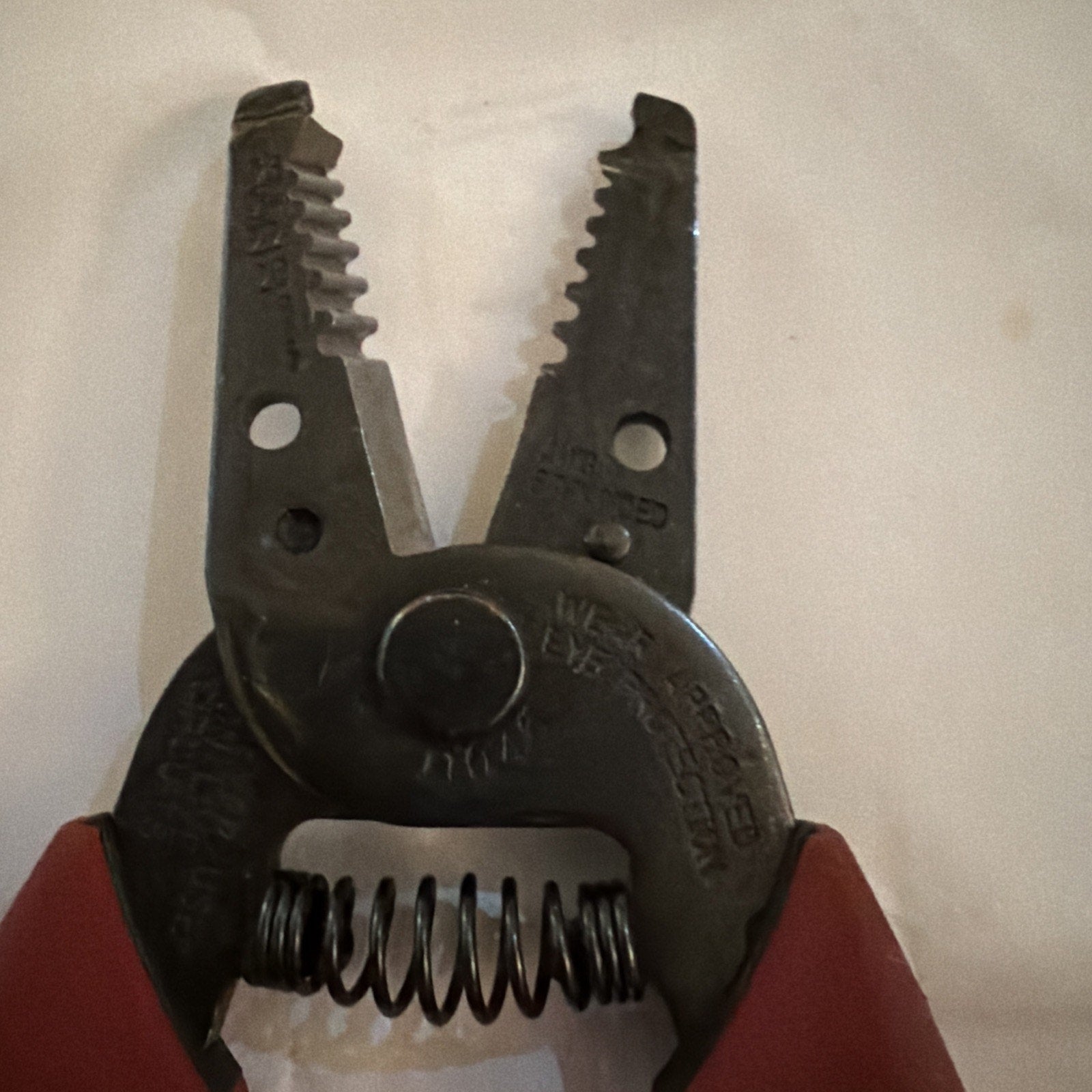 Close-up of Klein Tools Wire Stripper Cutter Pliers model 11046 showing cutting and stripping jaws with spring mechanism