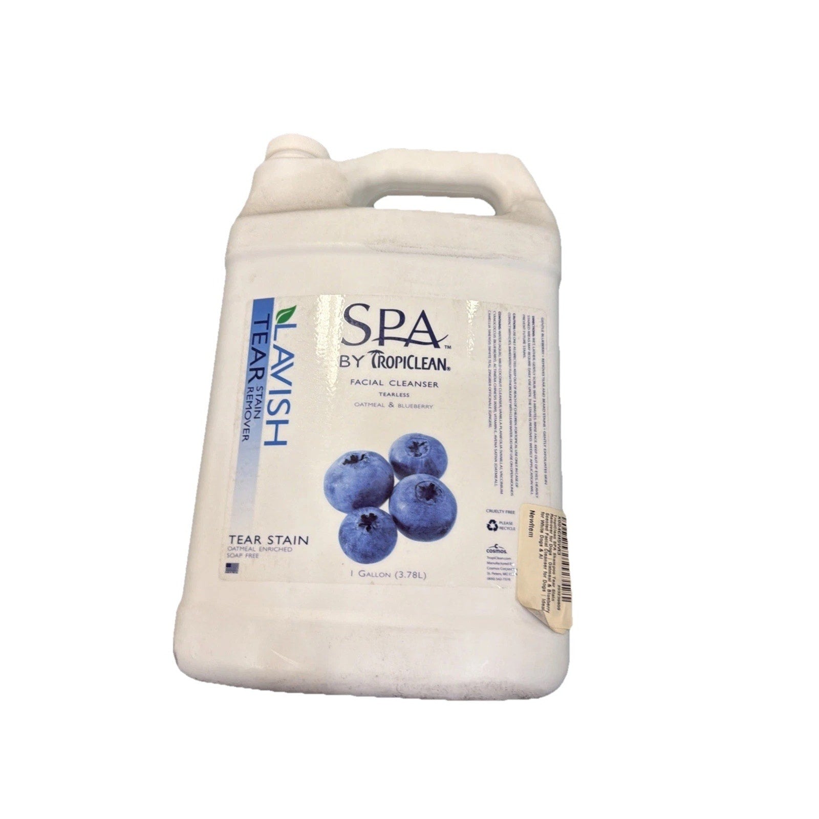 White plastic gallon container of Lavish Tear Stain remover featuring a label with blueberries and Spa by Tropiclean branding on a plain white background.