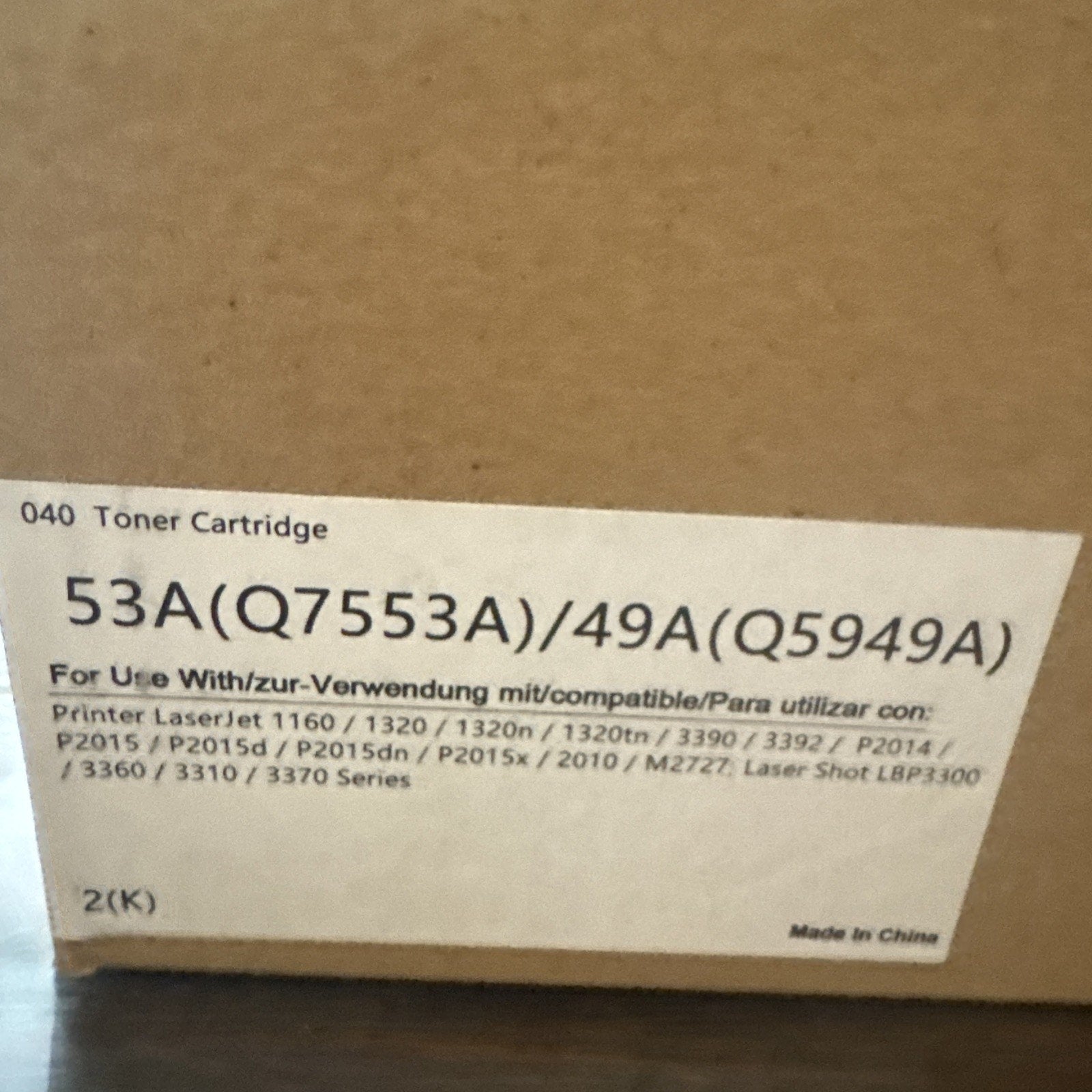 Brown cardboard box with a white label indicating toner cartridge models 53A (Q7553A) and 49A (Q5949A), compatible with various HP LaserJet printer models, made in China.