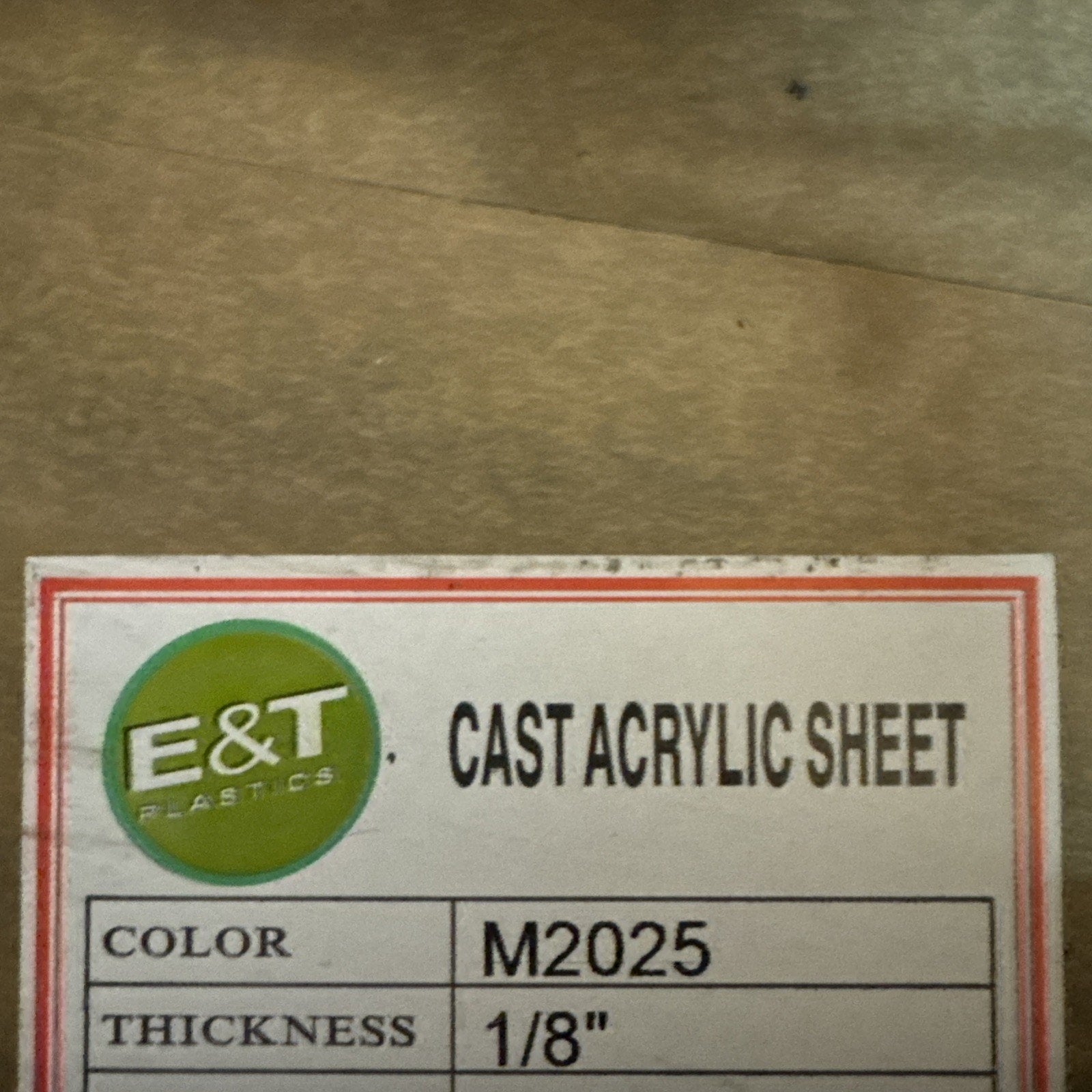 E&T Plastics label for cast acrylic sheet showing color M2025 and thickness 1/8 inch on white background