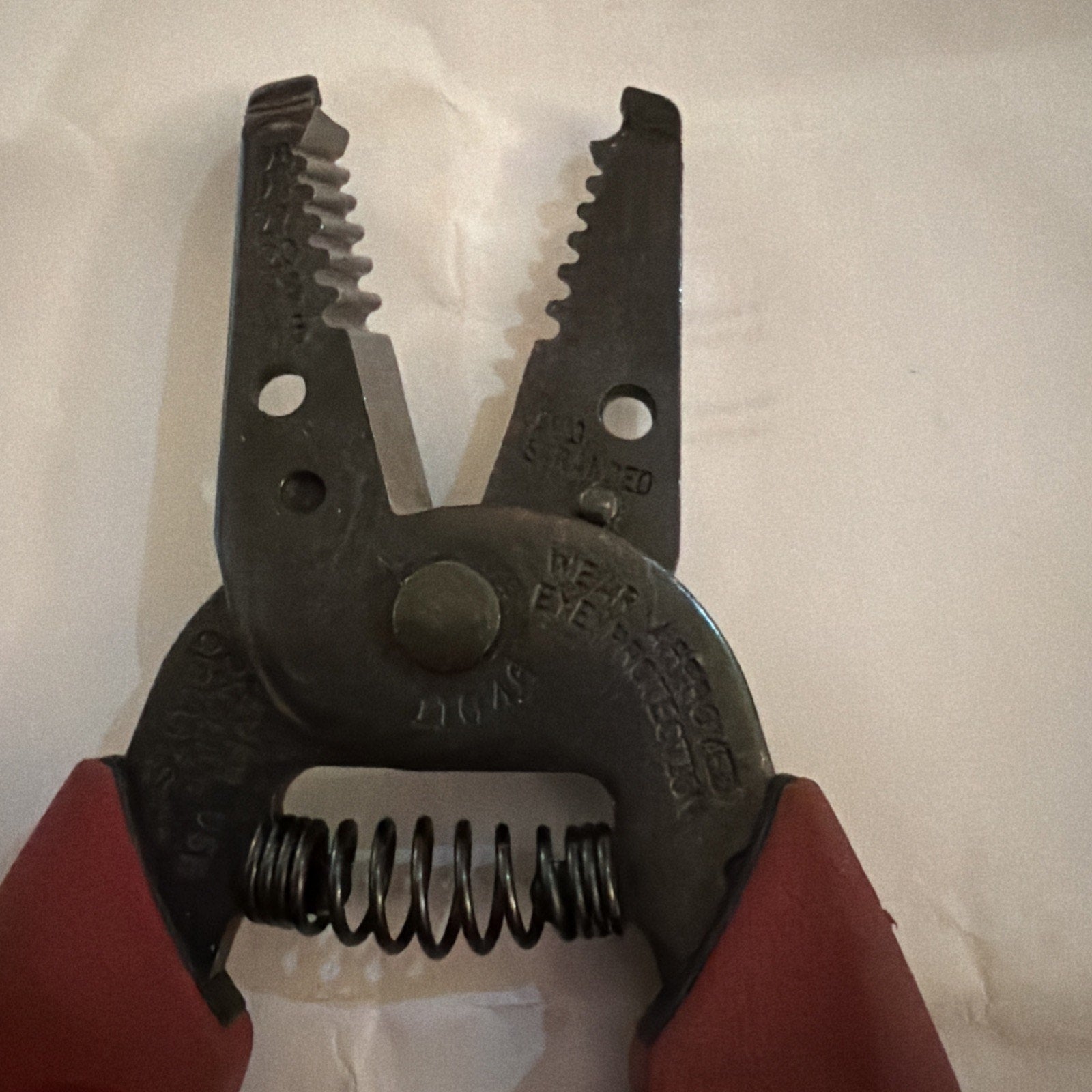Klein Tools 11046 wire stripper and cutter pliers showing metal jaws and red handles close-up view