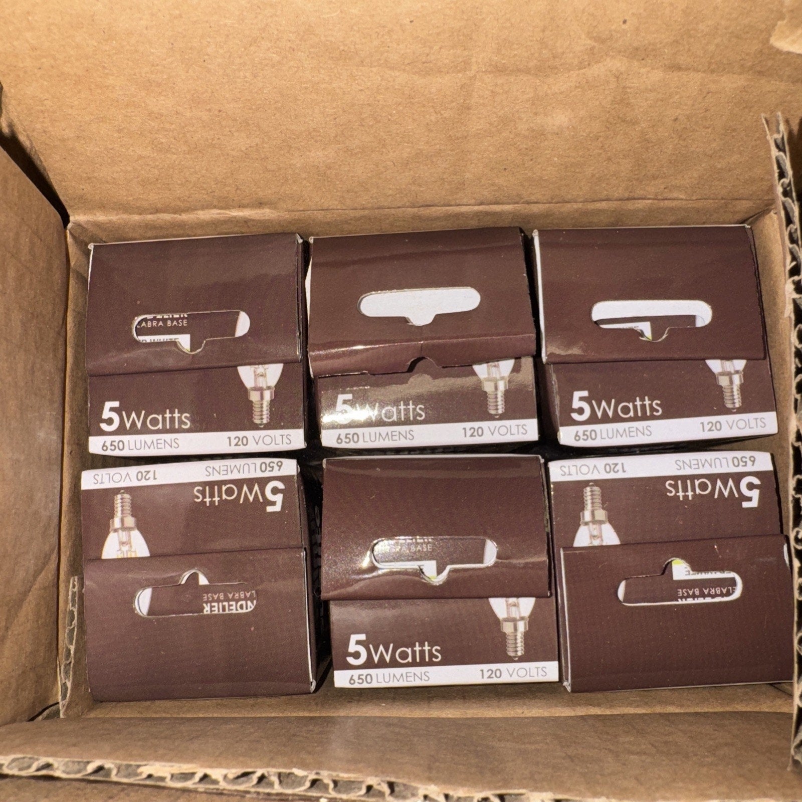 Six Sunlite chandelier LED bulbs 5 watt 650 lumens 120 volt in brown retail packaging inside cardboard box