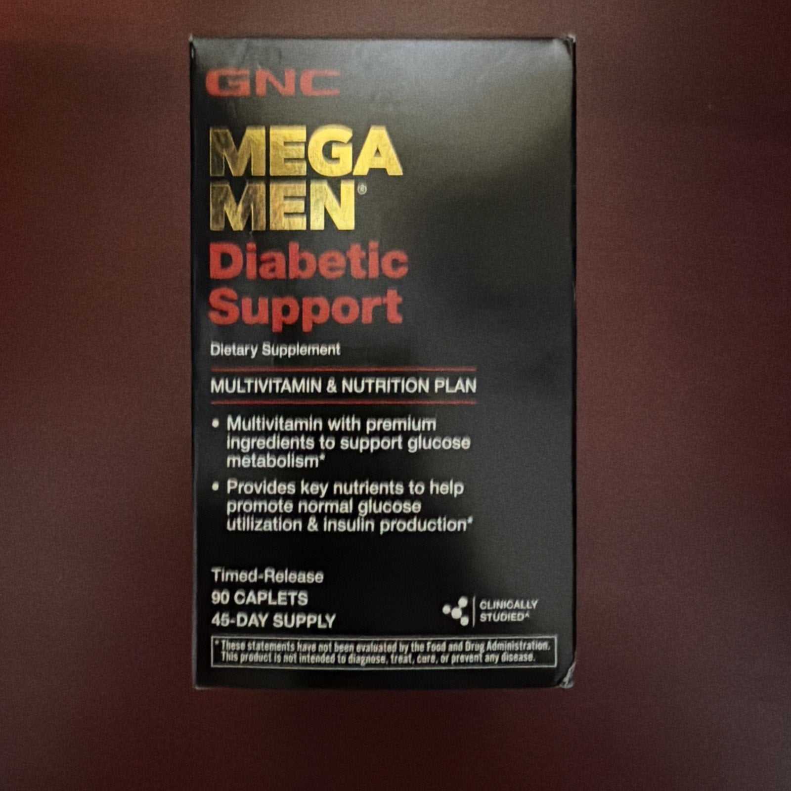 Black and red box of GNC Mega Men Diabetic Support dietary supplement featuring multivitamin and nutrition plan information, listing glucose metabolism and insulin production benefits.