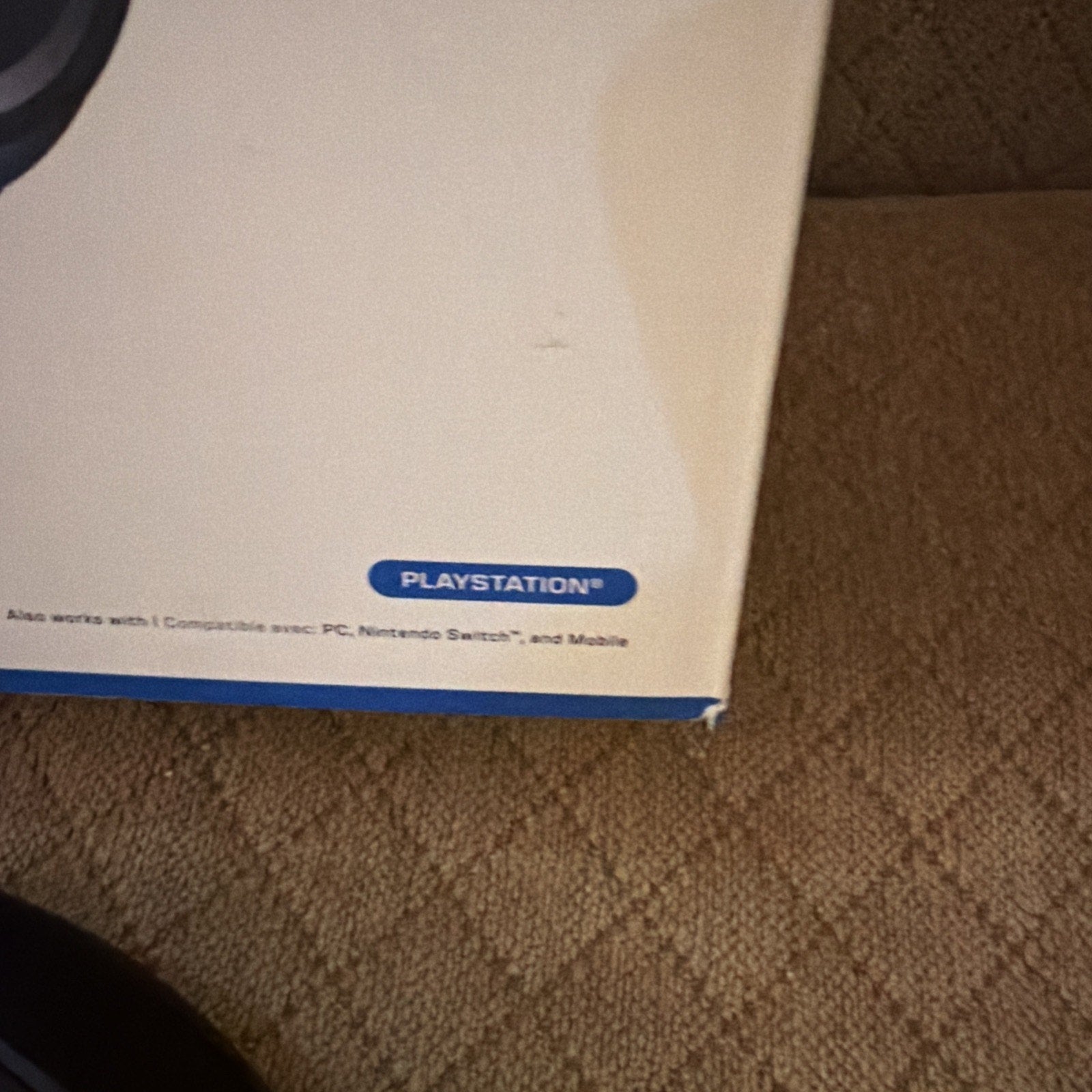 Corner of Turtle Beach Stealth 700 Gen 3 headset box showing PlayStation branding on carpet background