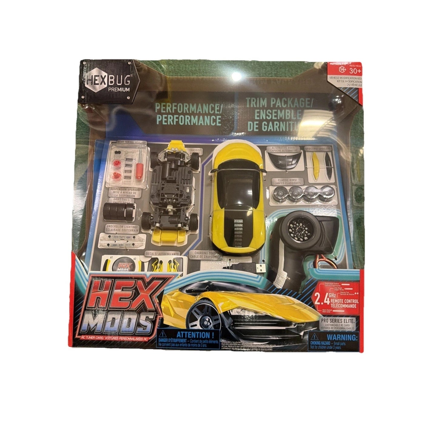 Remote-controlled yellow and black toy car kit with interchangeable parts and accessories displayed inside a performance trim packaging box.