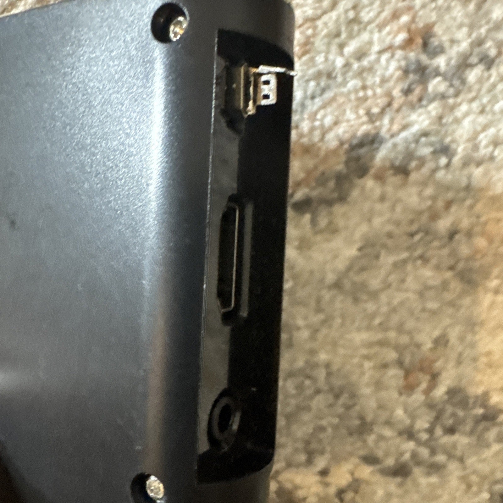 Close-up of black Revel Orbit and Guard scanner device showing USB and HDMI ports on side panel