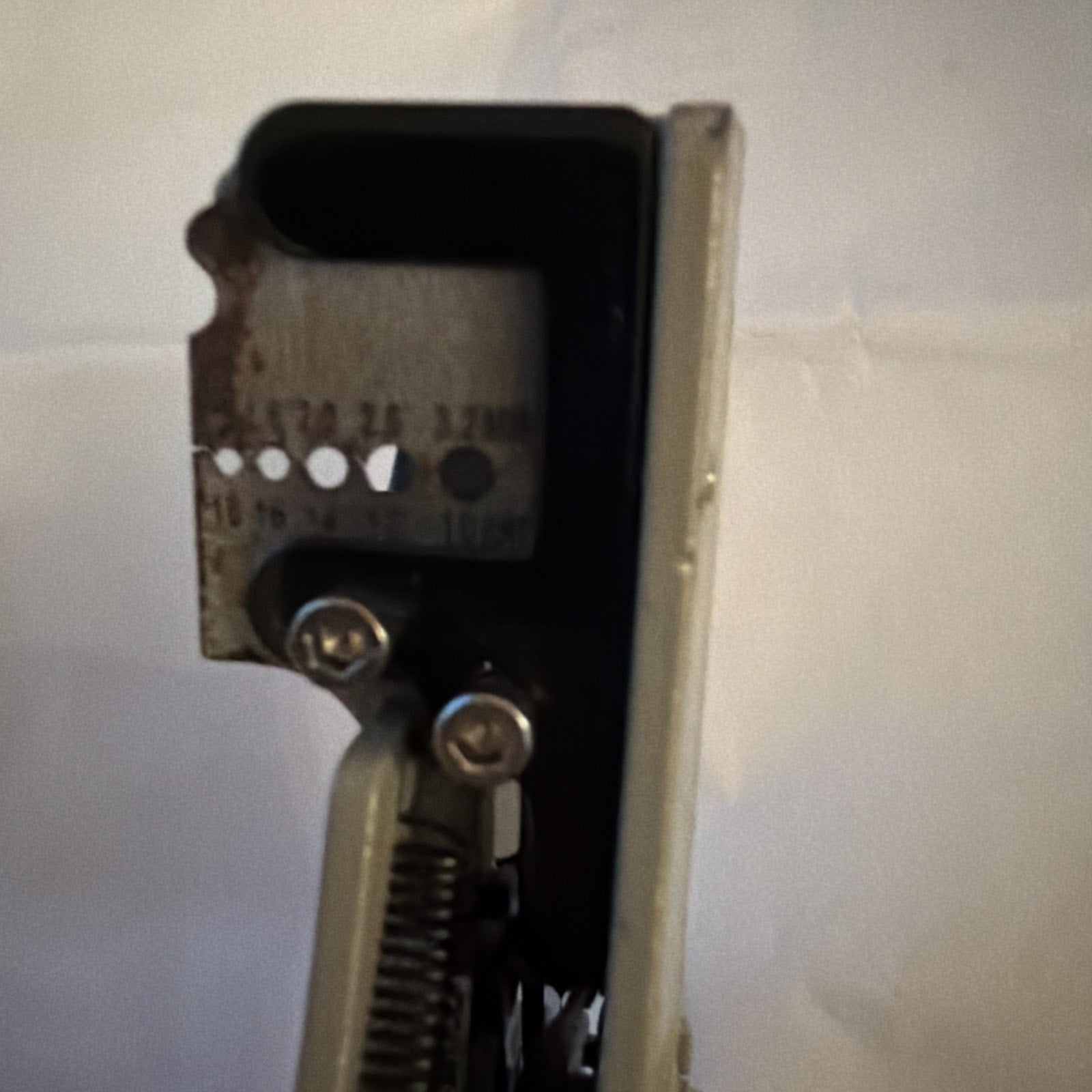 Close-up side view of Electrical Wire Stripper Tool Type B showing blade and wire gauge holes on metal head