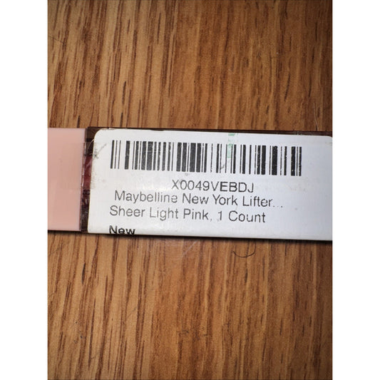 Barcode label for Maybelline New York Lifter Lip Gloss Sheer Light Pink 1 count on wooden surface