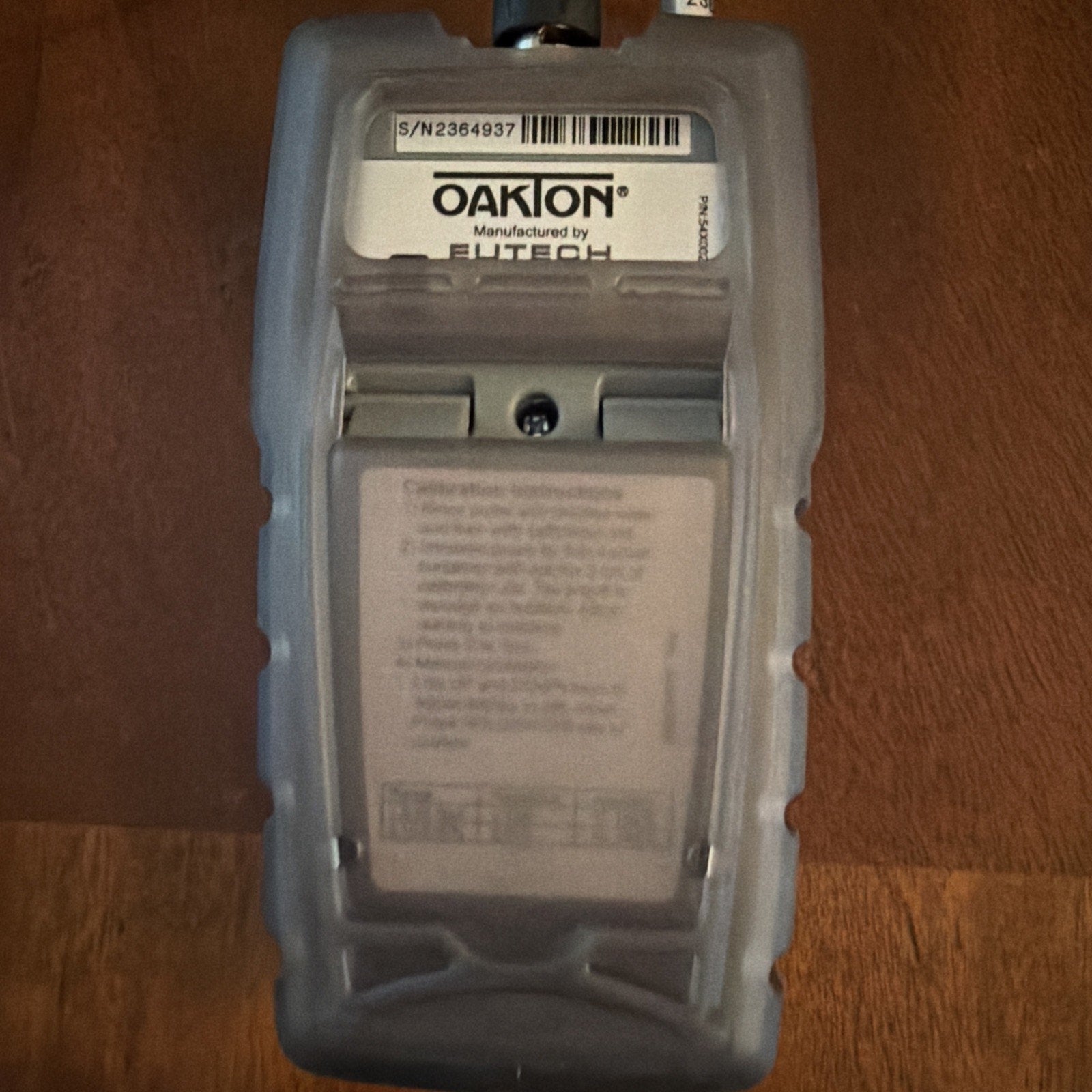 Back view of ORIGINAL Oakton SALT 6+ Handheld Salinity Meter showing label and serial number on wooden surface