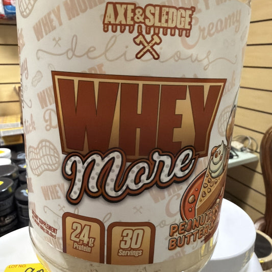 Container of Axe & Sledge Whey More protein powder in peanut butter flavor, featuring 24 grams of protein and 30 servings per container with beige and brown packaging.