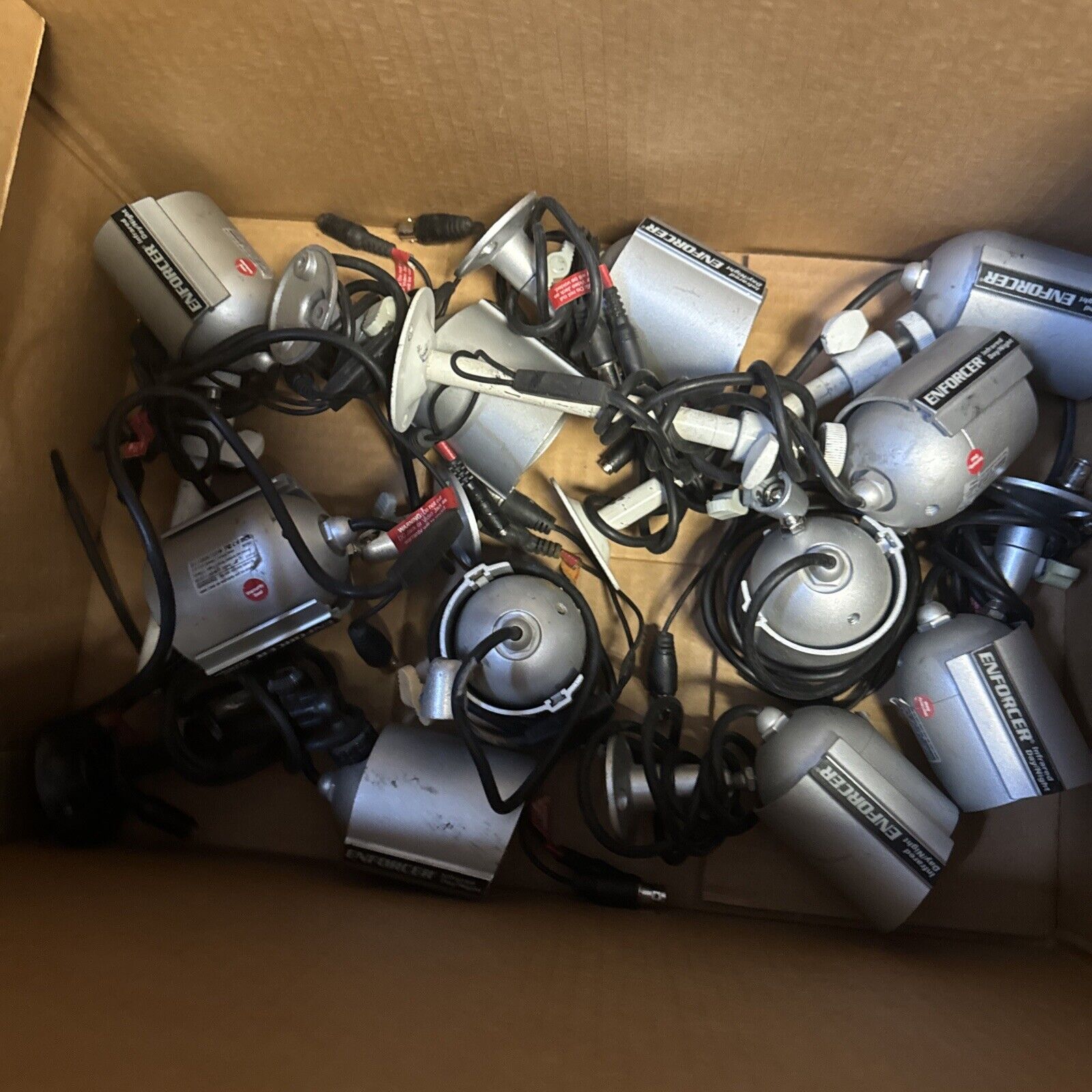 Lot of 11 Enforcer EV-1323C12DW security cameras with cables in cardboard box for home surveillance use