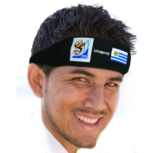 Smiling man wearing a black headband featuring the 2010 FIFA World Cup South Africa logo, the Uruguay flag, and "Uruguay" text on a white background.