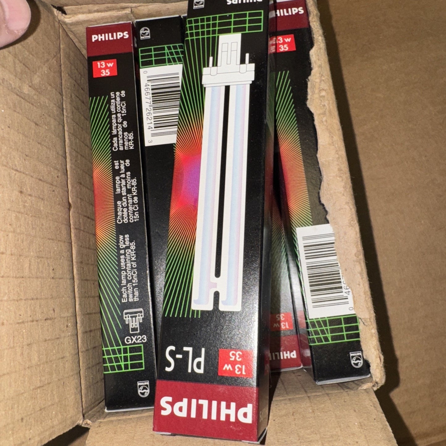 Lot of 10 Philips PL-S 13W/35 fluorescent lamp light bulbs in original black and red packaging inside cardboard box