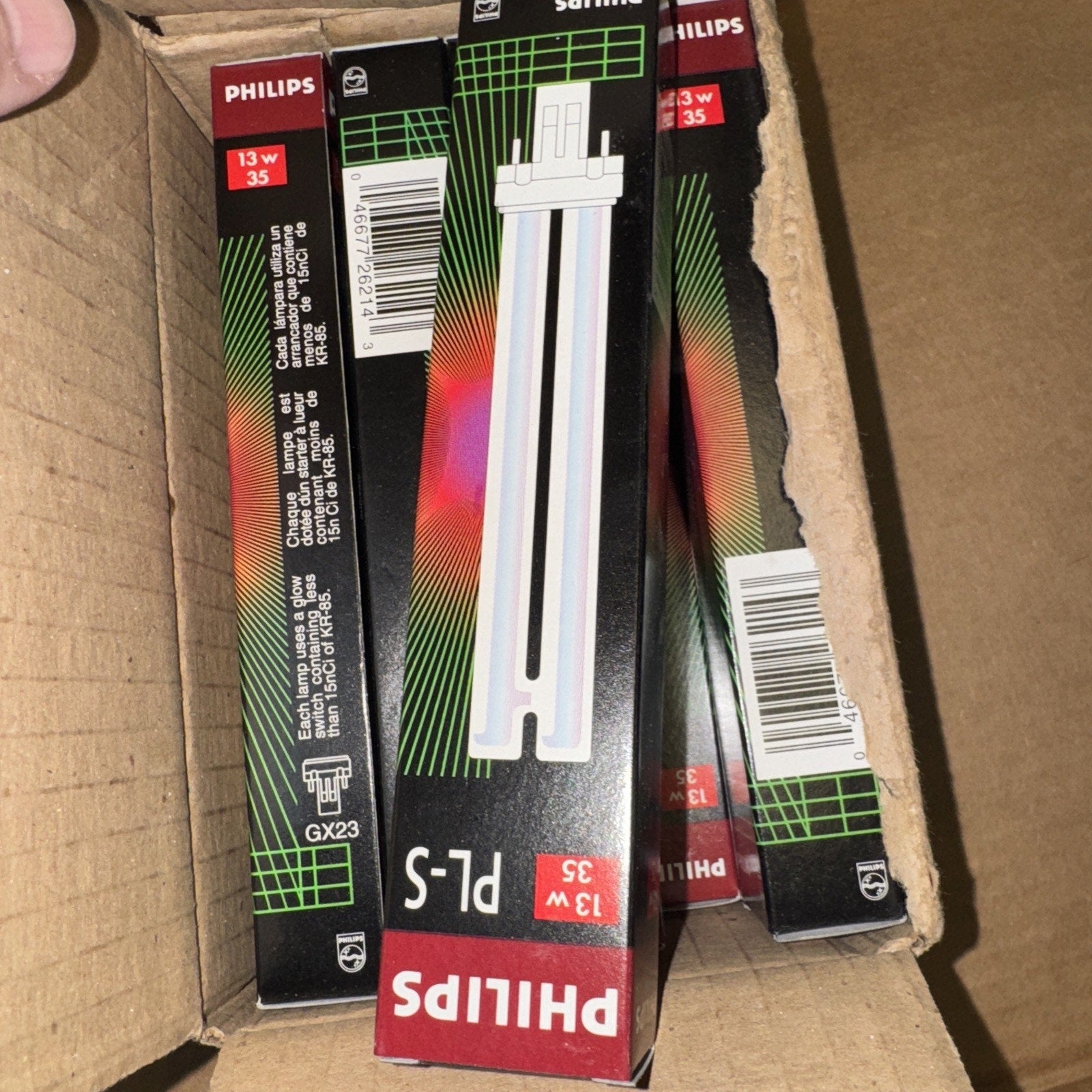 Lot of 10 Philips PL-S 13W/35 fluorescent lamp light bulbs in original black and red packaging inside cardboard box