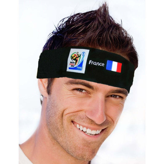Man with short dark hair smiling while wearing a black sports headband displaying the 2010 FIFA World Cup South Africa logo, the French flag, and the word "France" on a white background.