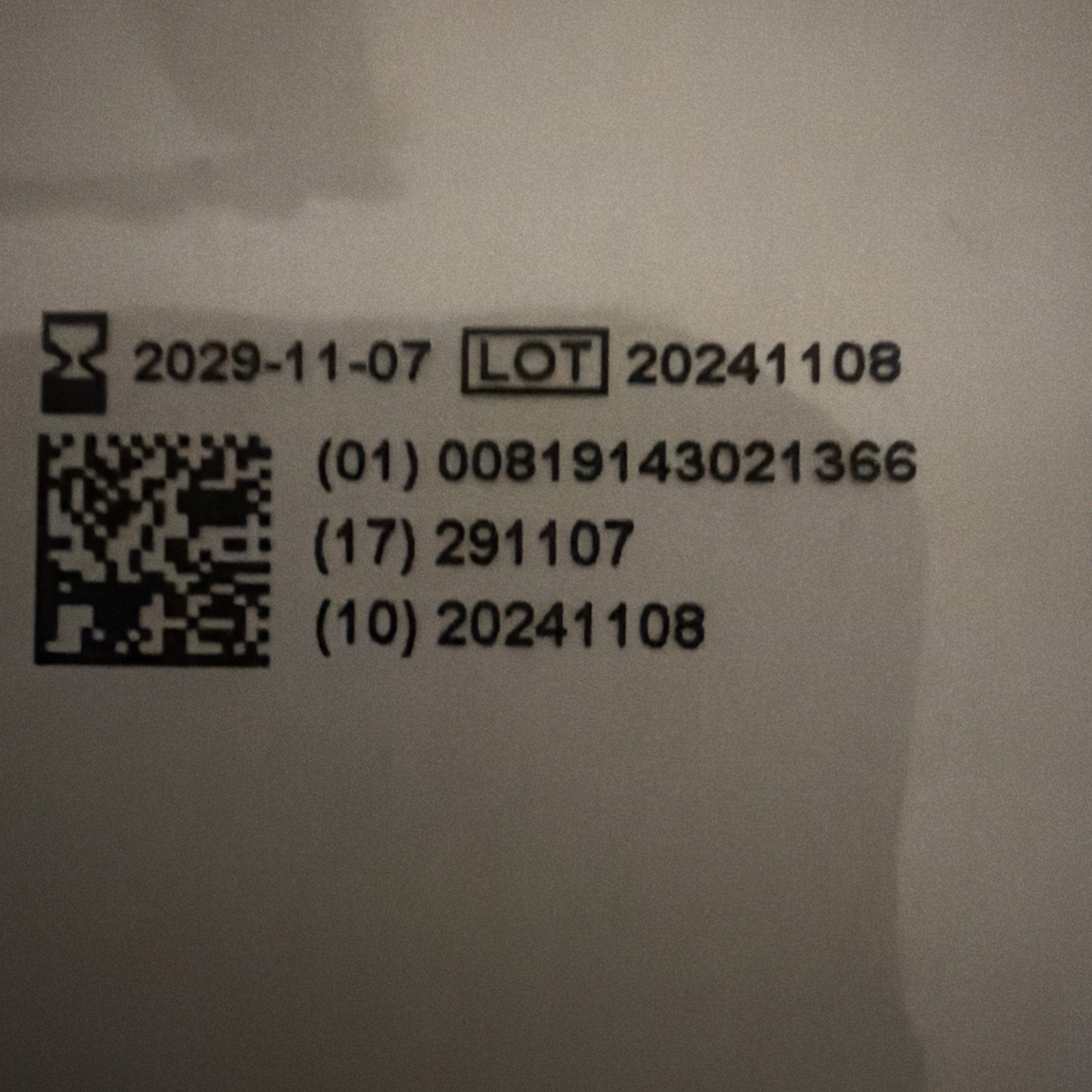 Black printed expiration date "2029-11-07," lot number "20241108," and product codes alongside a QR code on a white background.