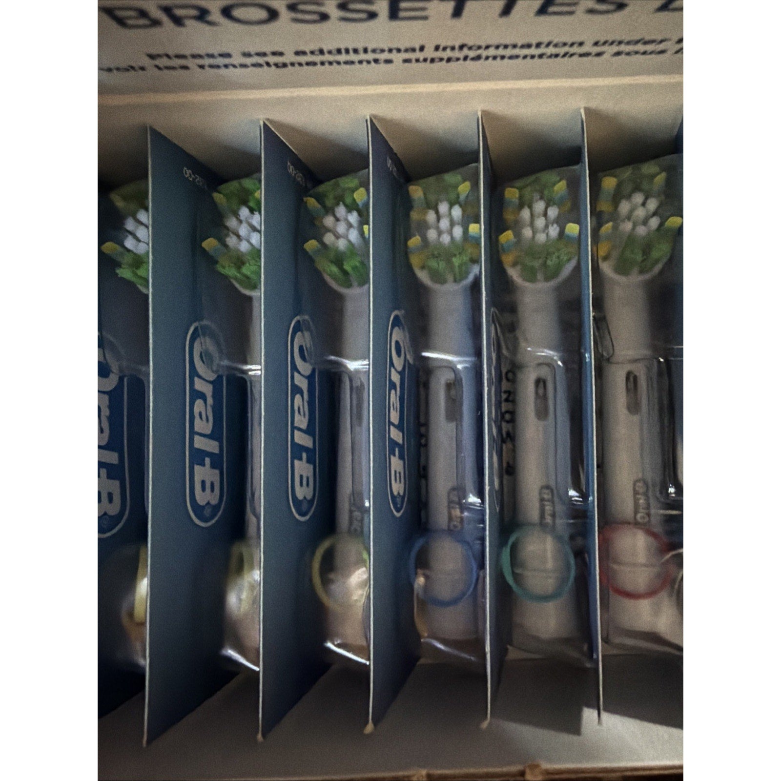 Oral-B FlossAction X replacement electric toothbrush heads 9-count pack showing individual brush heads in packaging