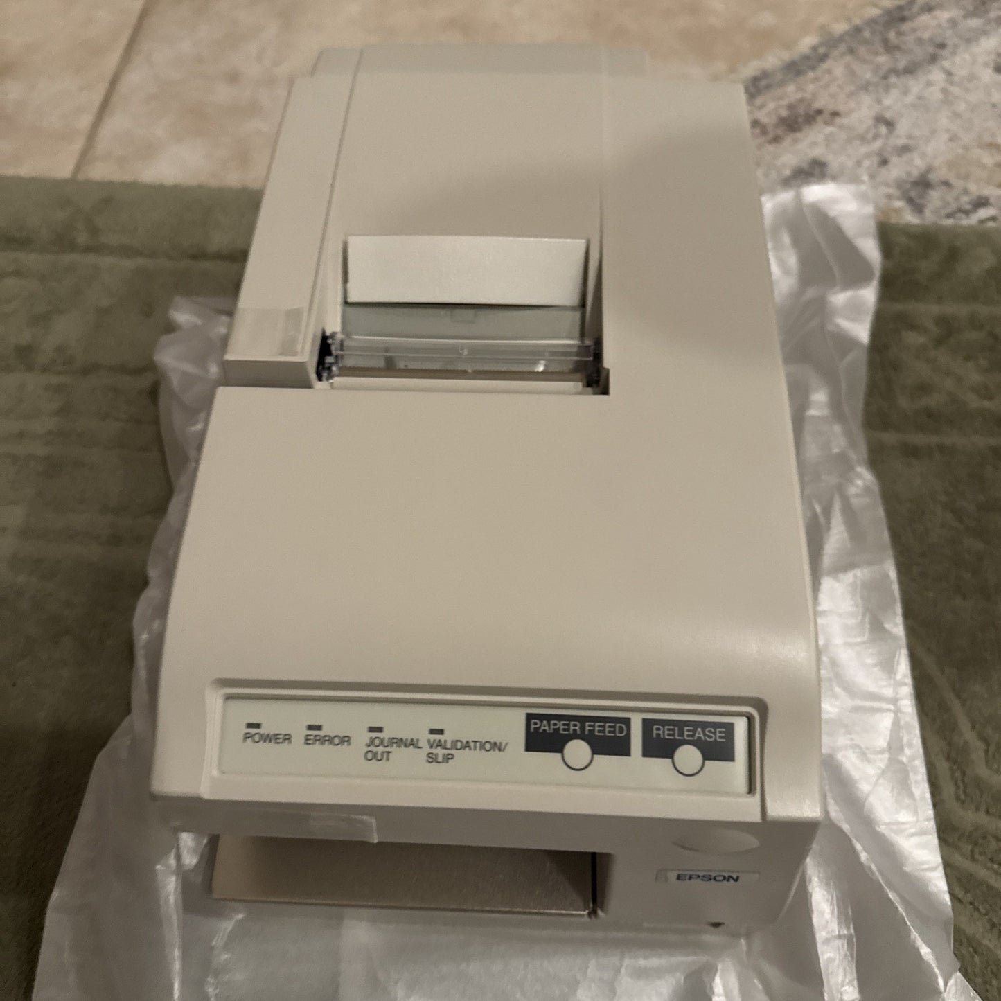 EPSON TM-U375P Model M115A dot matrix POS receipt printer with paper feed and release buttons angled top view