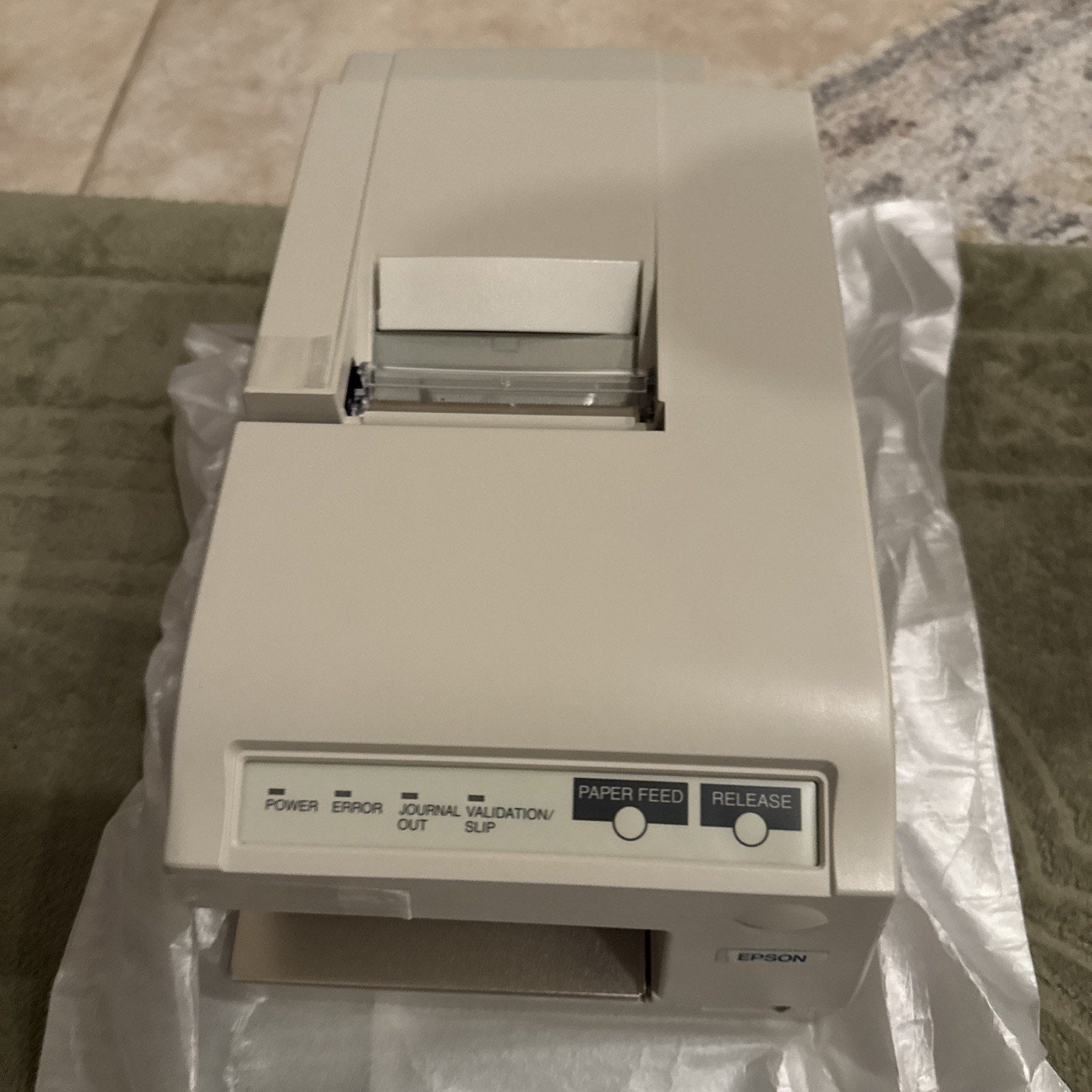 EPSON TM-U375P Model M115A dot matrix POS receipt printer with paper feed and release buttons angled top view