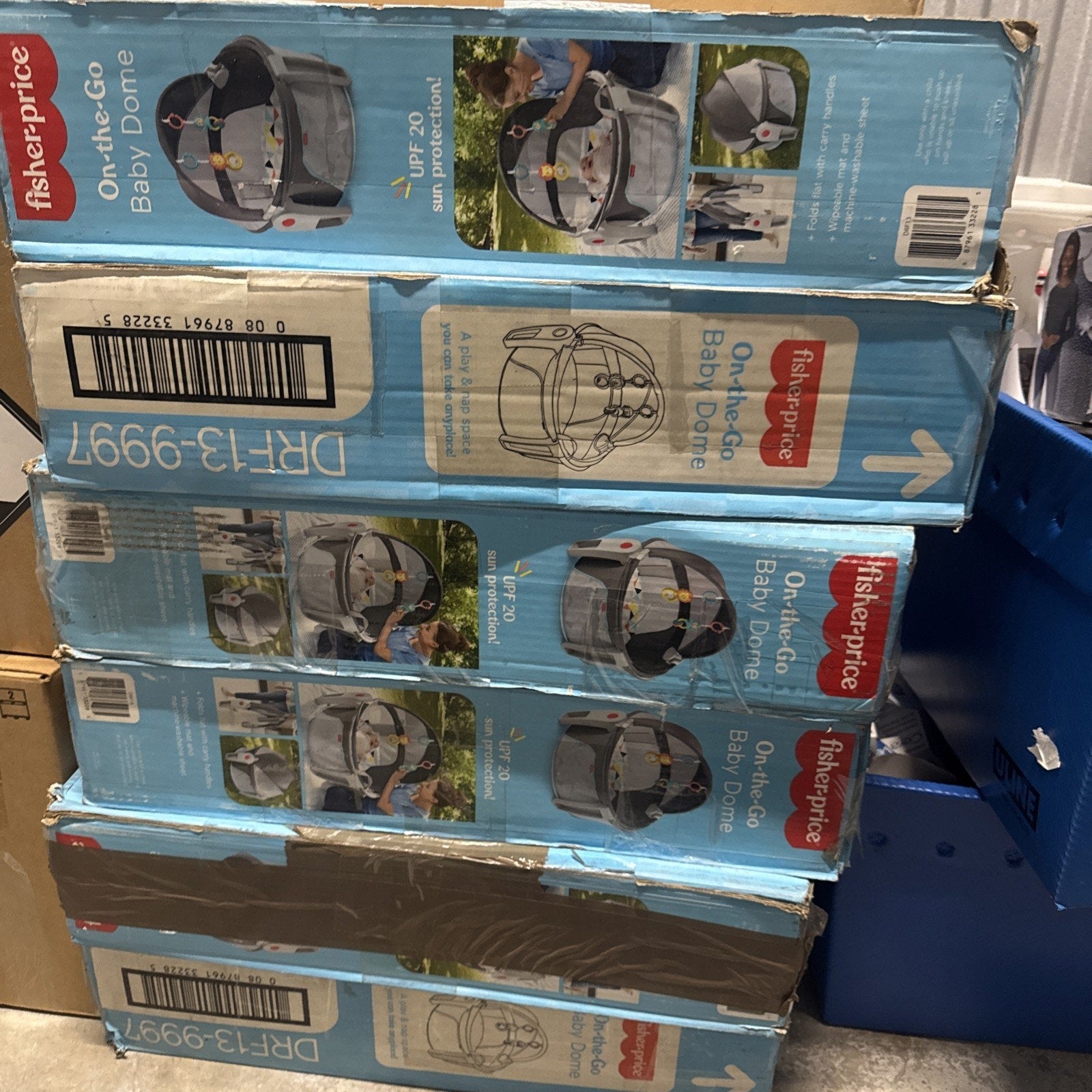 Stack of Fisher-Price On-the-Go Baby Dome play shades in blue boxes showing portable shaded baby chairs