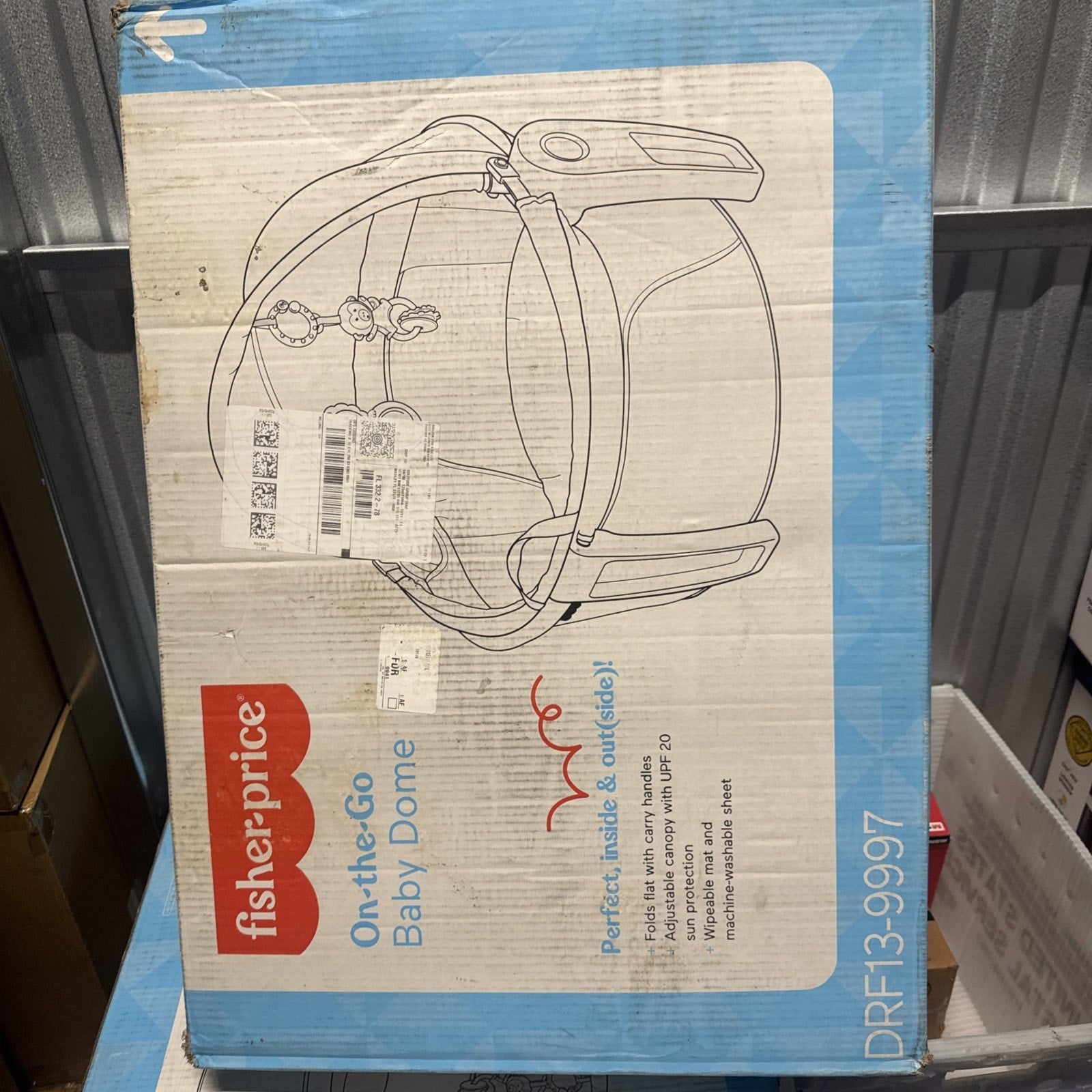 Fisher-Price On-the-Go Baby Dome box showing portable infant play shade with handle and toy attachments illustration