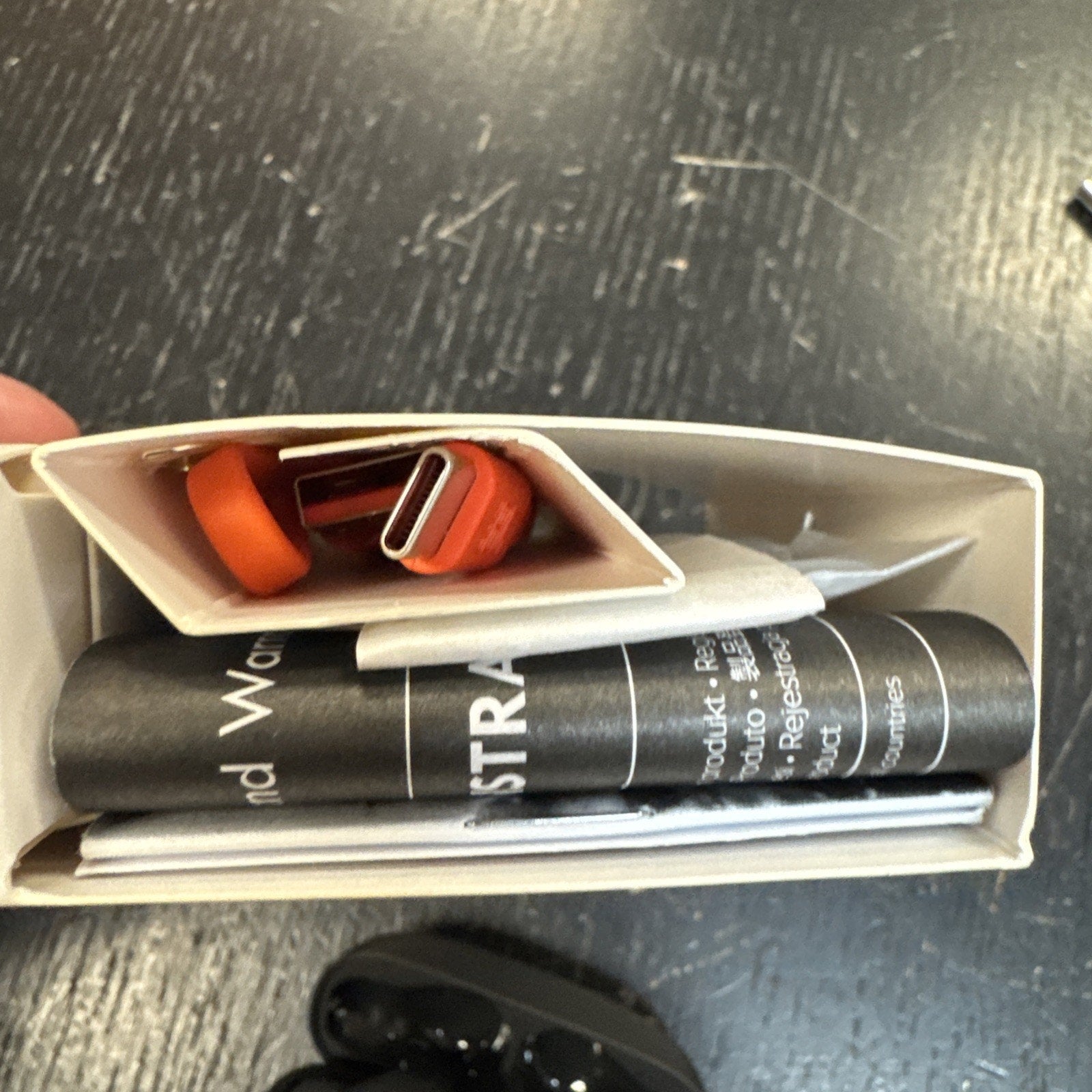 Top view of JBL Vibe Beam True Wireless Bluetooth Earbuds box contents including USB charging cable and product manuals in white packaging
