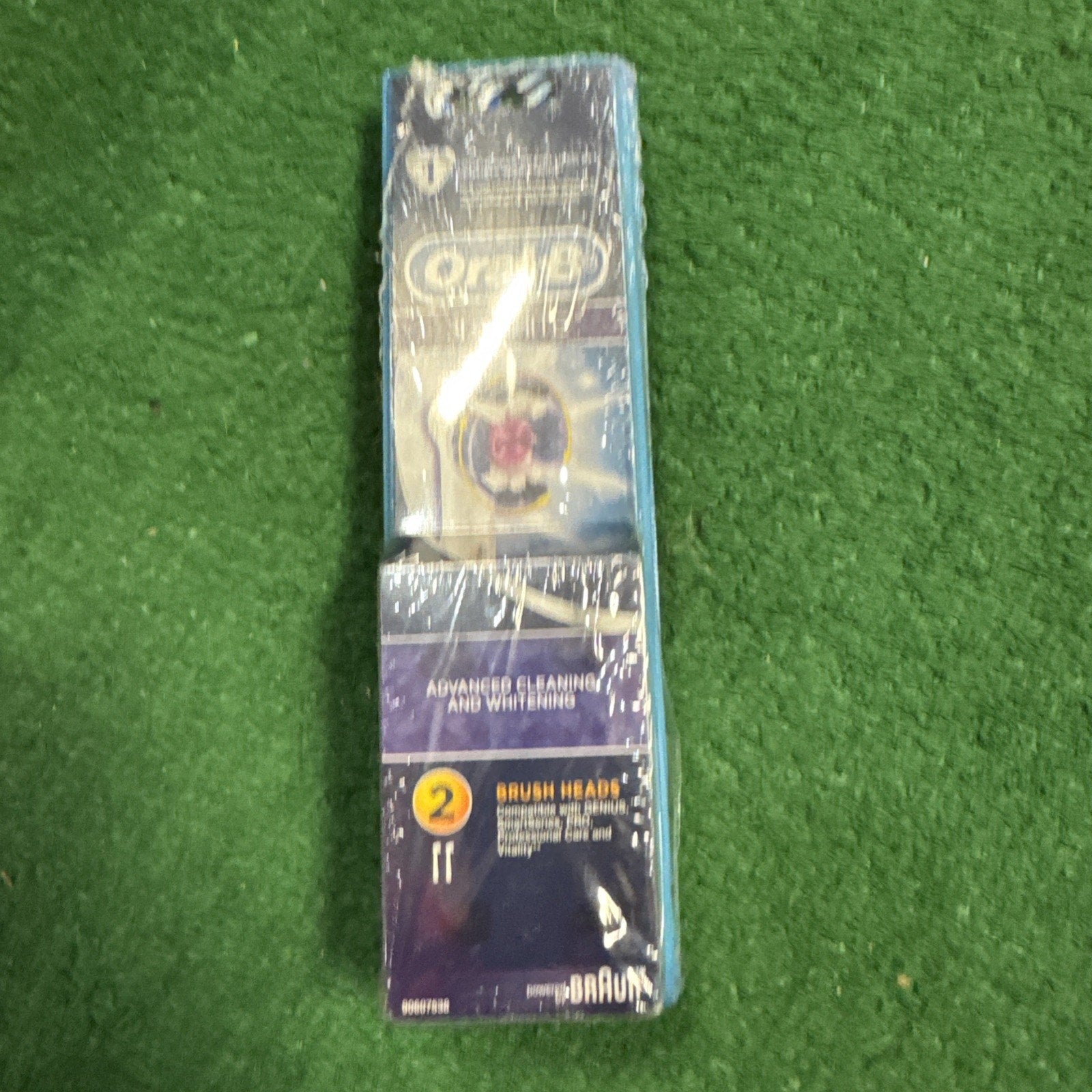 Oral B 3D White replacement electric toothbrush heads pack showing two brush heads in sealed packaging on green background
