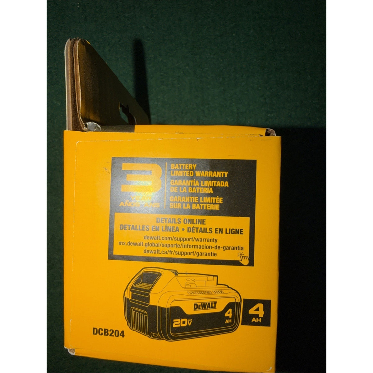 Yellow and black DeWalt battery packaging box showing a 20V 4Ah lithium-ion battery image, warranty details in English, Spanish, and French, and the model number DCB204.