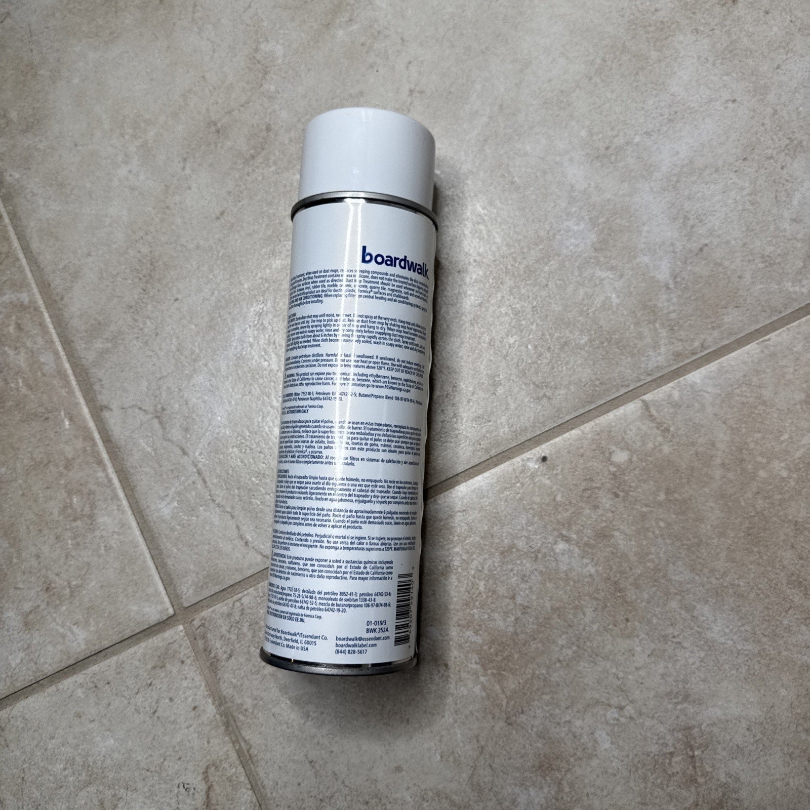 Boardwalk 352AEA 18 oz. spray dust mop treatment can with white cap on beige tile floor showing product label text
