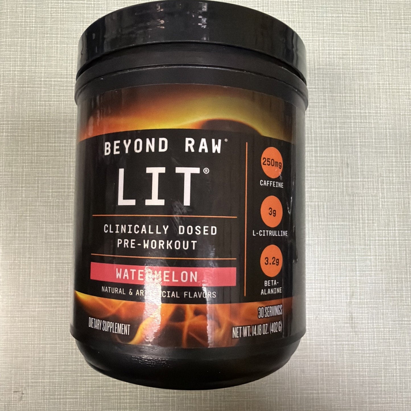 Black container of Beyond Raw LIT pre-workout supplement in watermelon flavor, featuring 250mg caffeine, 3g L-citrulline, and 3.2g beta-alanine with natural and artificial flavors.