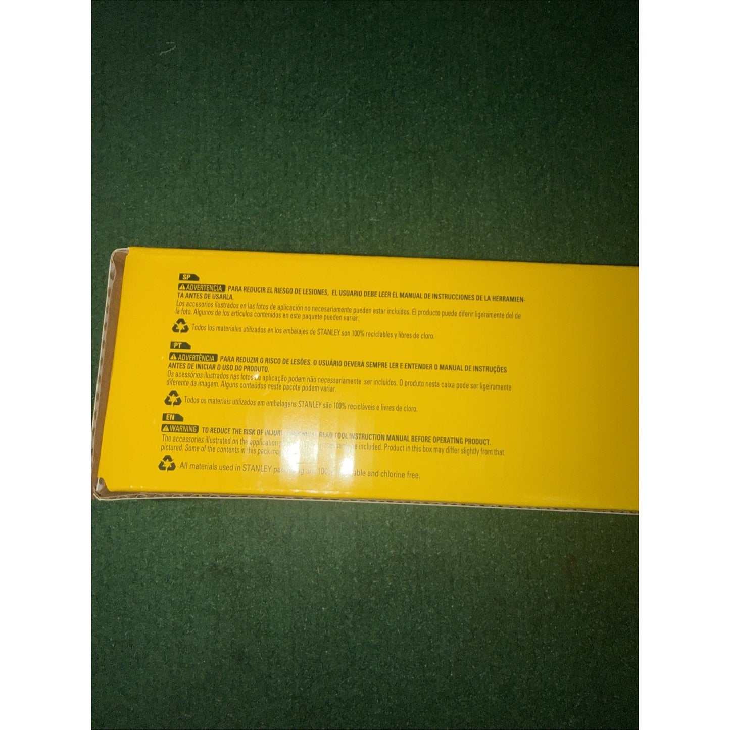 Yellow product packaging box showing safety warnings and instructions in multiple languages including English, Spanish, and French, with caution symbols printed on the back panel.