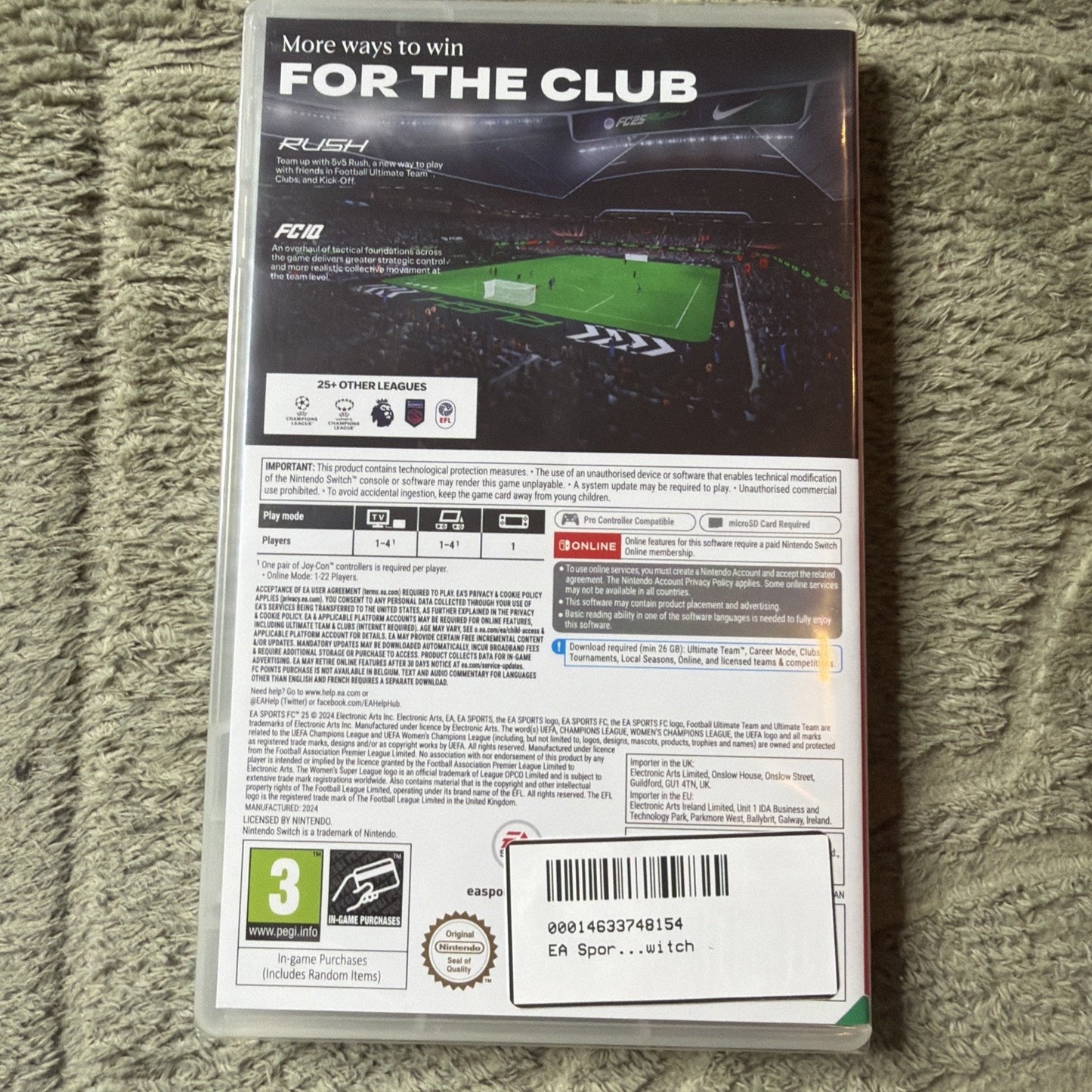 Back of a Nintendo Switch game case showing gameplay screenshots, league logos, multiplayer options, technical requirements, age rating, and barcode on a green textured surface background.
