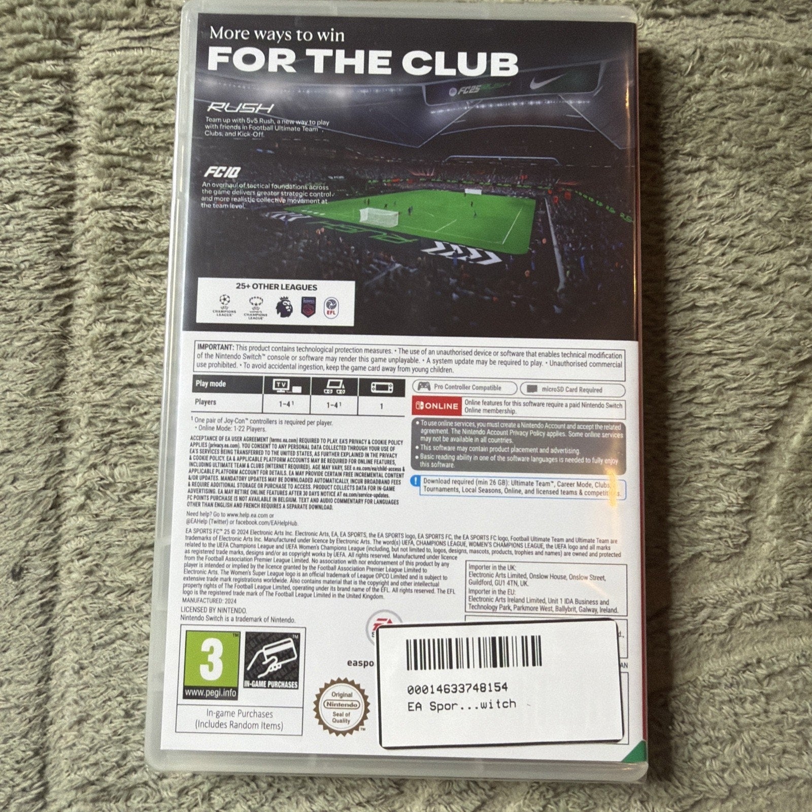Back of a Nintendo Switch game case showing gameplay screenshots, league logos, multiplayer options, technical requirements, age rating, and barcode on a green textured surface background.