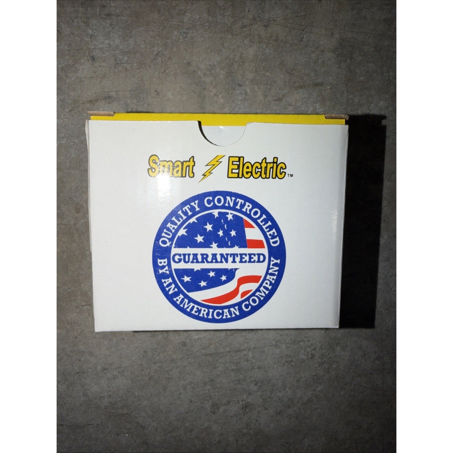 White cardboard box with yellow interior edges, featuring the "Smart Electric" logo in yellow and black, and a circular blue, red, and white label stating "Quality Controlled Guaranteed by an American Company.