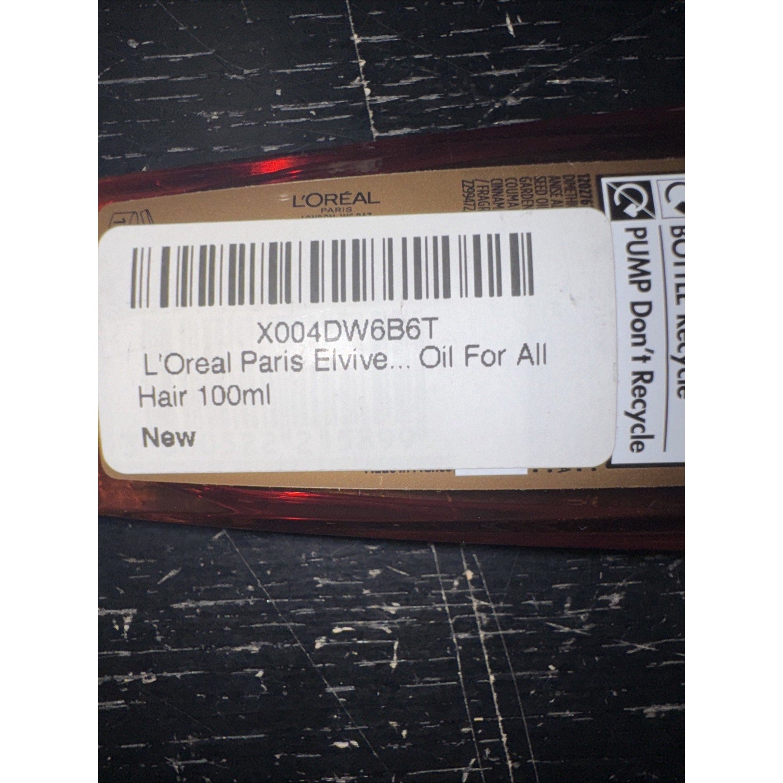 L'Oreal Paris Elvive Extraordinary Oil hair serum bottle label showing product name and size 100ml