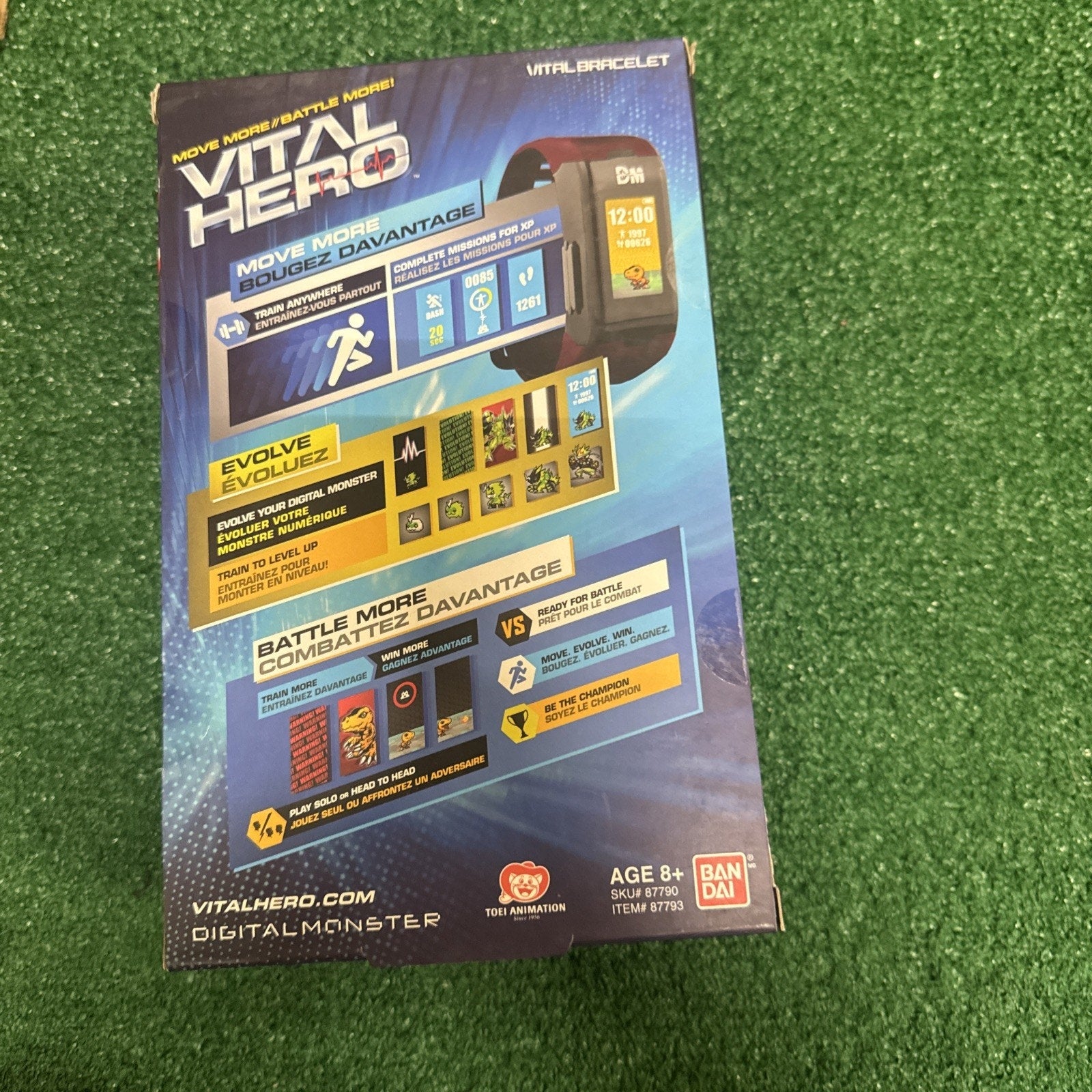 Bandai Vital Hero Digimon red bracelet packaging showing fitness tracker and battle features on grass background