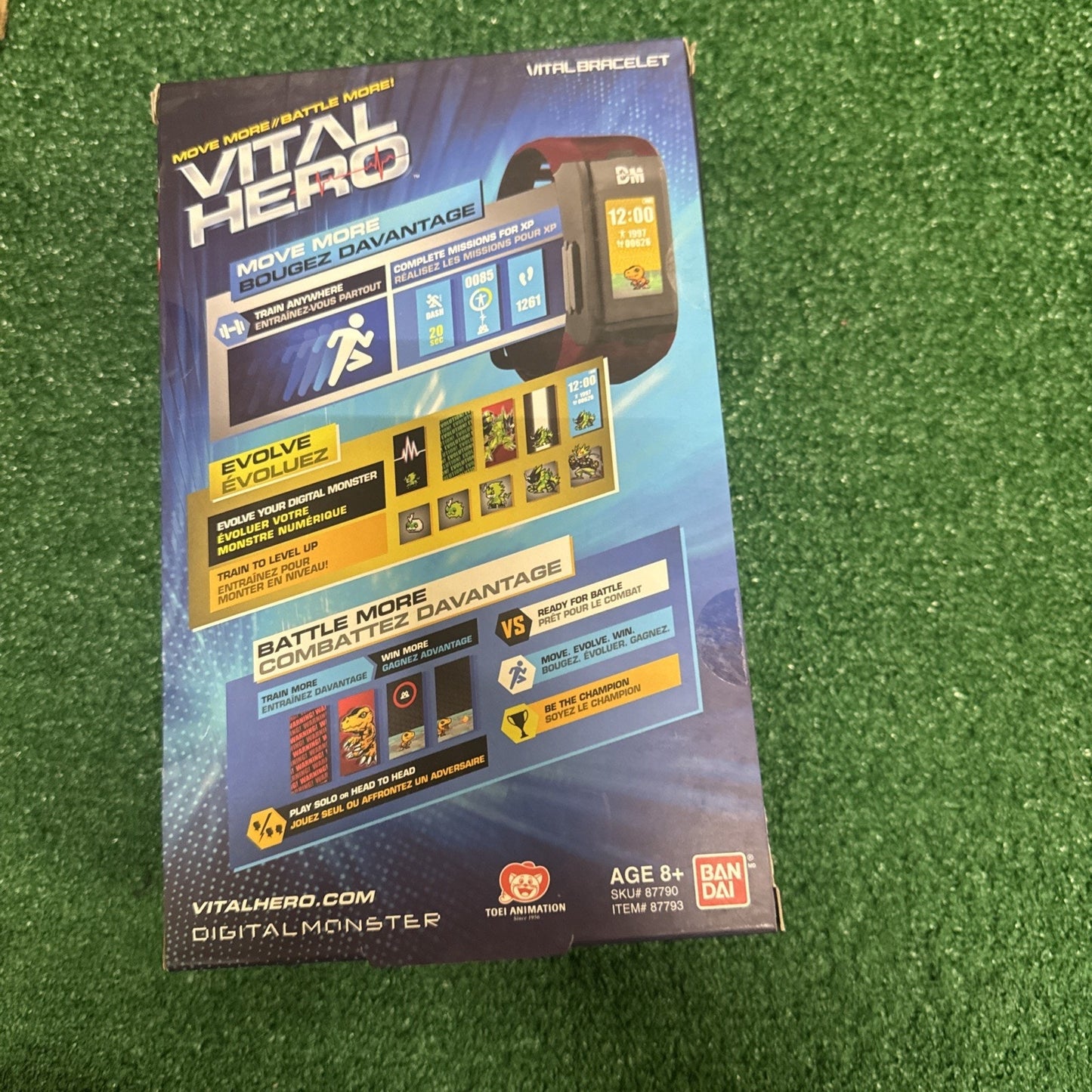 Bandai Vital Hero Digimon red bracelet packaging showing fitness tracker and battle features on grass background