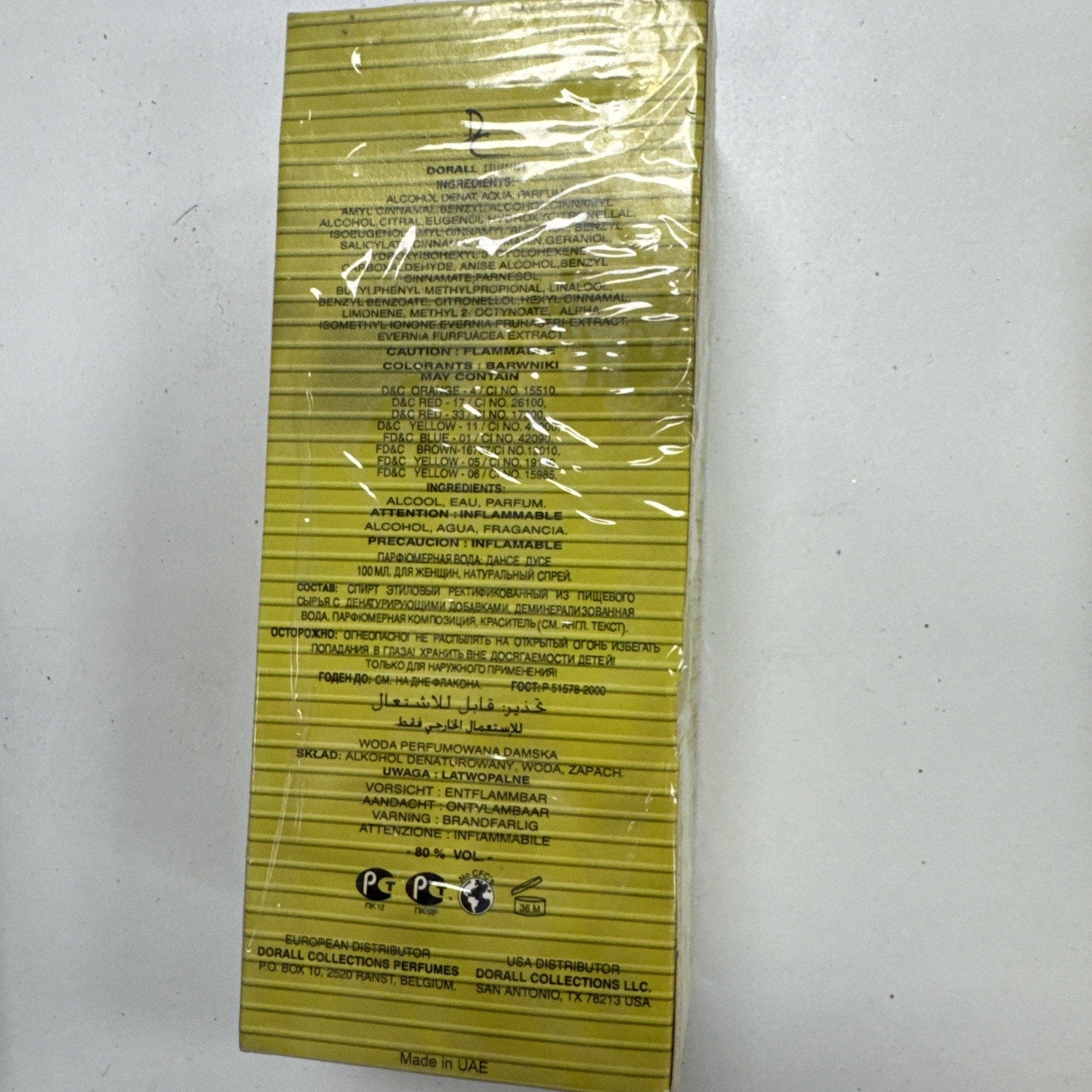 Back of Danse Douce Dorall Eau de Parfum Spray box showing ingredient list and safety warnings on yellow packaging