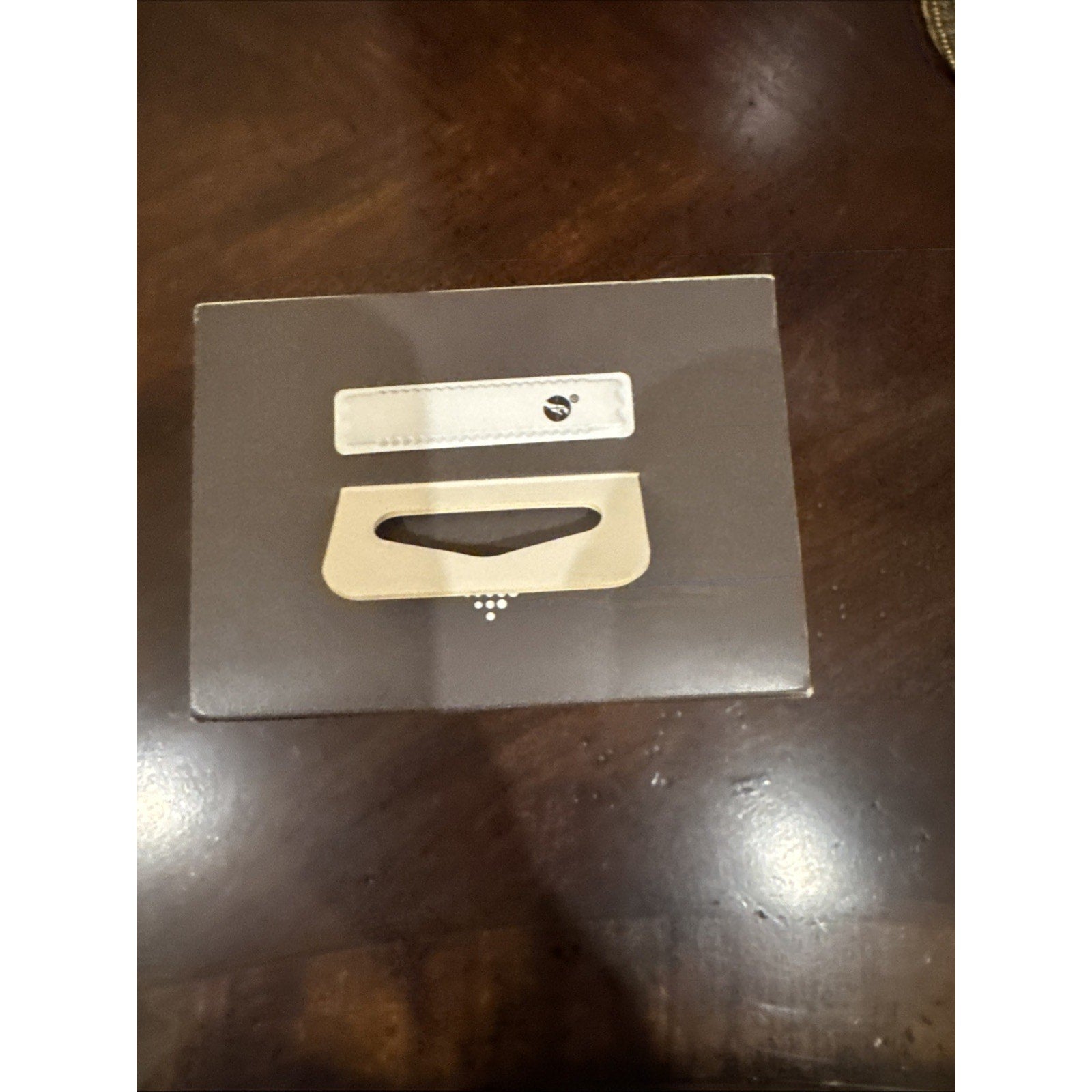 Brown box packaging for Fitbit Versa 4 Fitness Smartwatch with beige strap and device silhouette on front cover