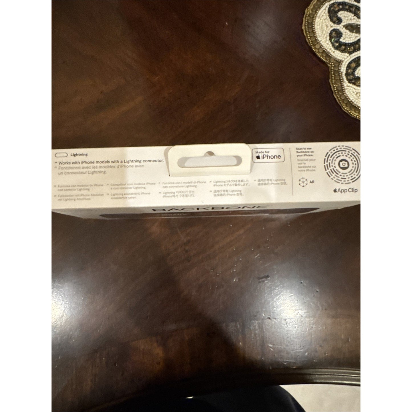 Backbone One Mobile Gaming Controller for iPhone packaging showing Lightning connector compatibility and Apple App Clip details