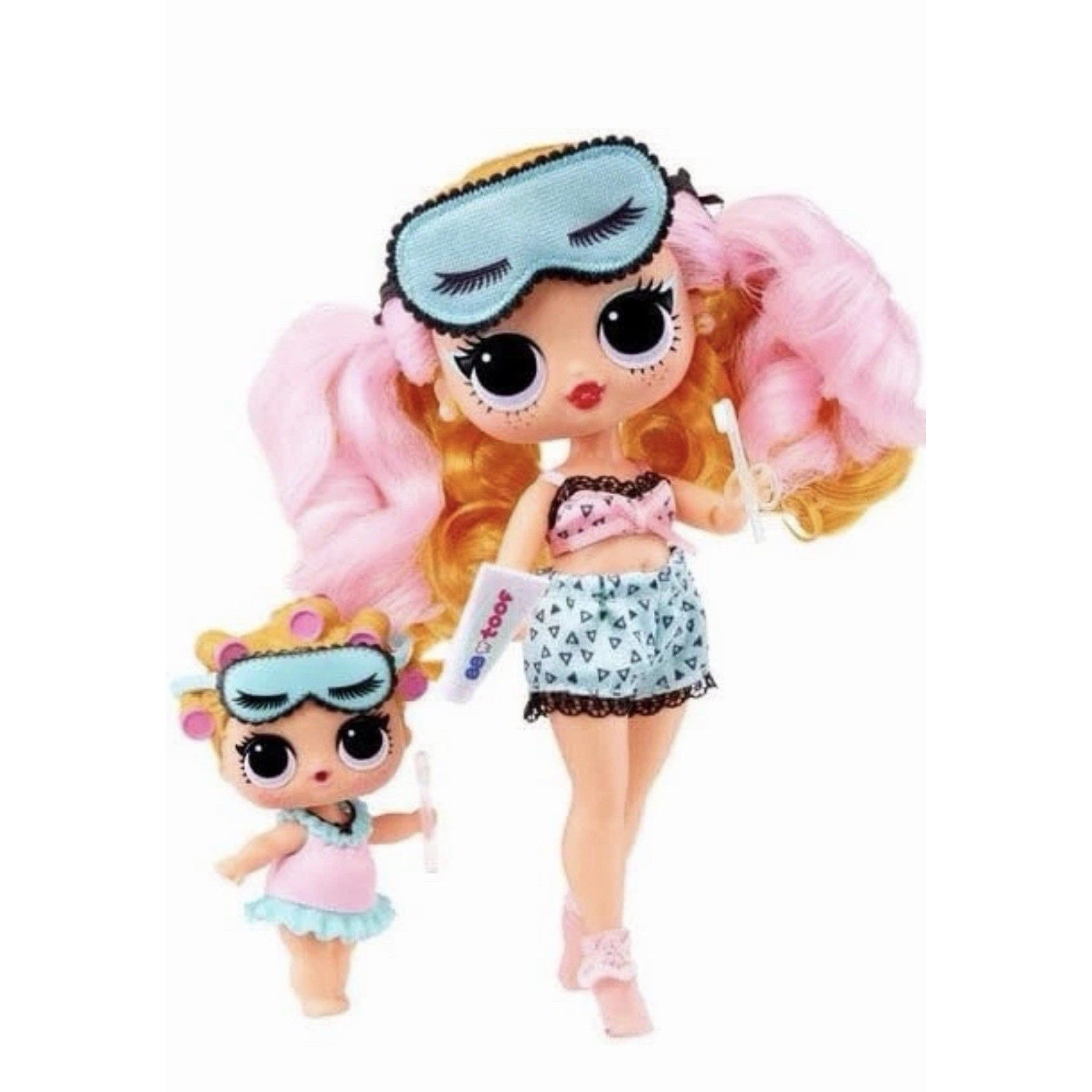 Two dolls with large eyes dressed in sleepwear; the larger doll wears a pink top and blue shorts with a blue sleep mask on her head, while the smaller doll wears a pink and blue outfit with matching eye mask and hair rollers.