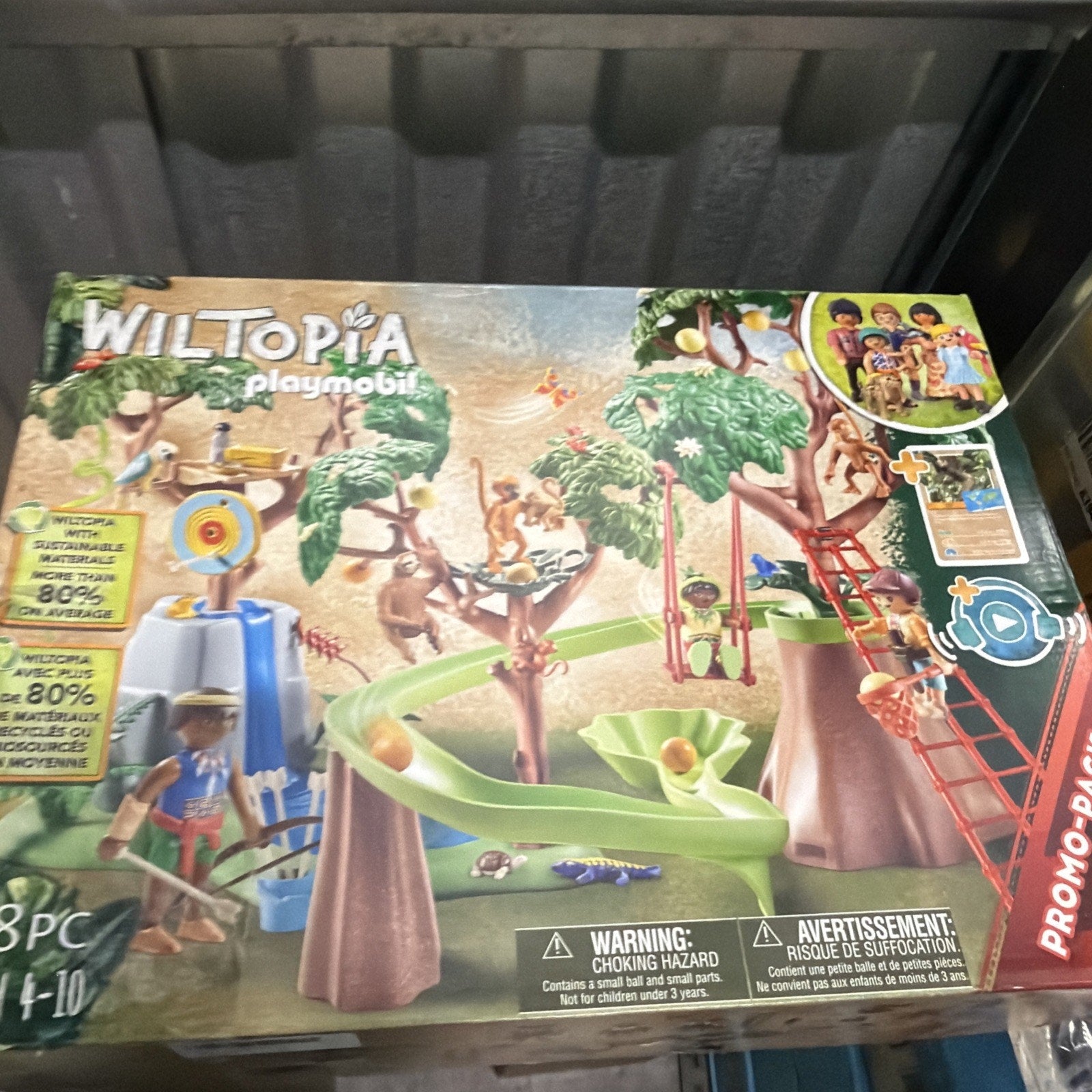 Playmobil Wiltopia playset featuring a treehouse scene with multiple monkey figures, a slide, a swing, and various accessories designed for children aged 4 to 10.