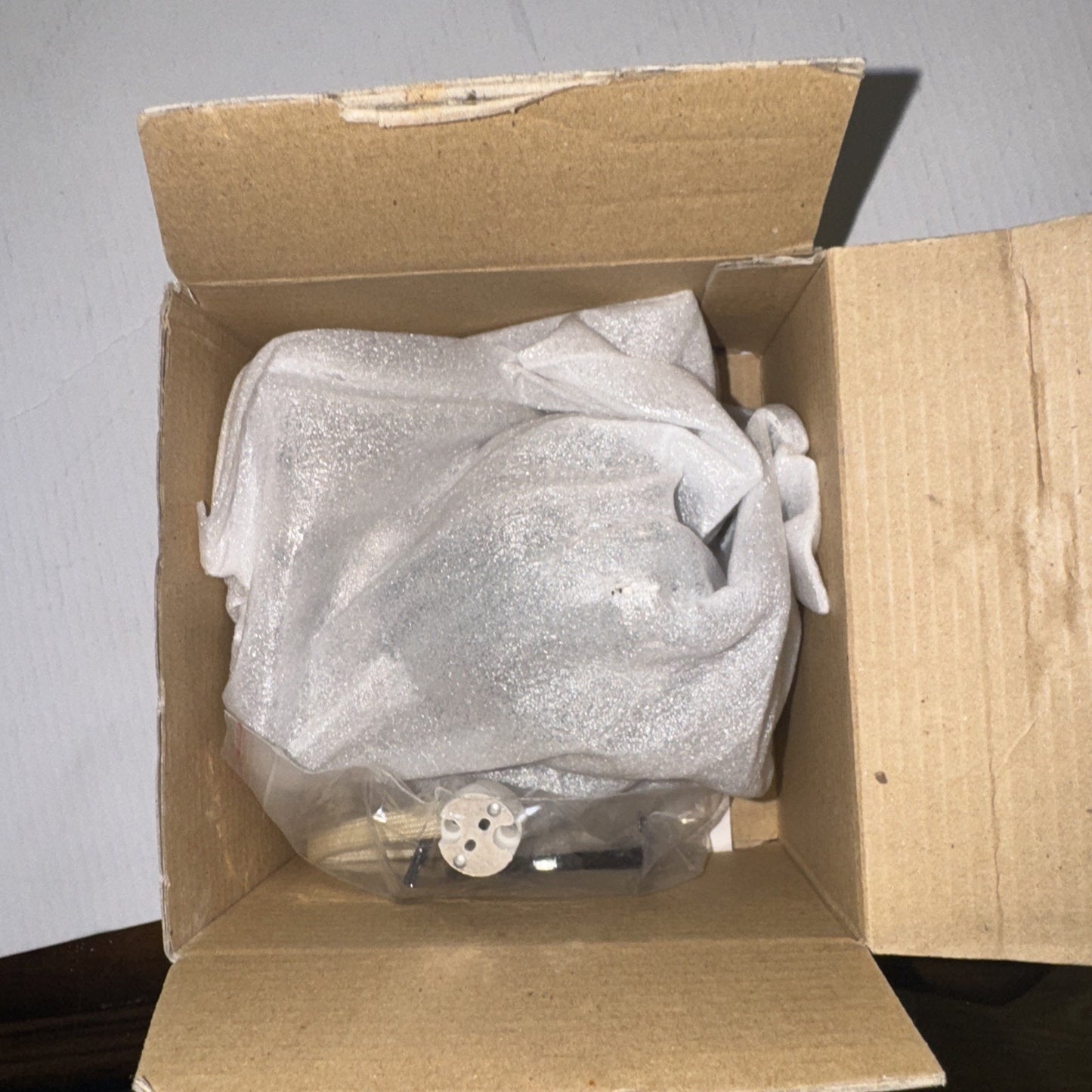 Con-Tech Lighting CTR1625 low volt recessed housing shown inside open cardboard box with protective wrapping and mounting hardware visible