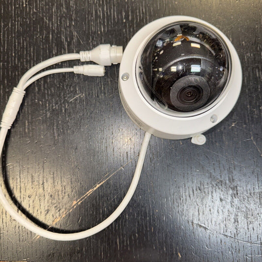 Hikvision DS2CD2123G0I outdoor IR dome security camera with white casing and connected cables on dark surface