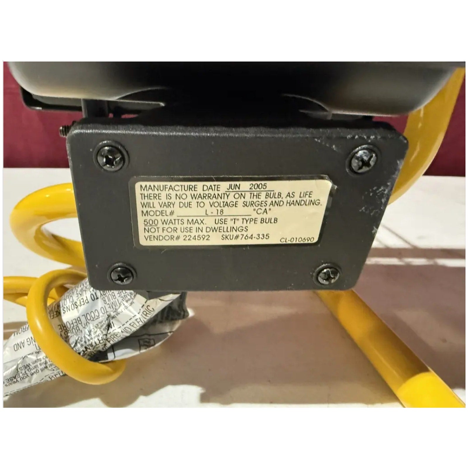 Heavy duty work light model L 18 showing label with manufacturing date and electrical specifications on black housing