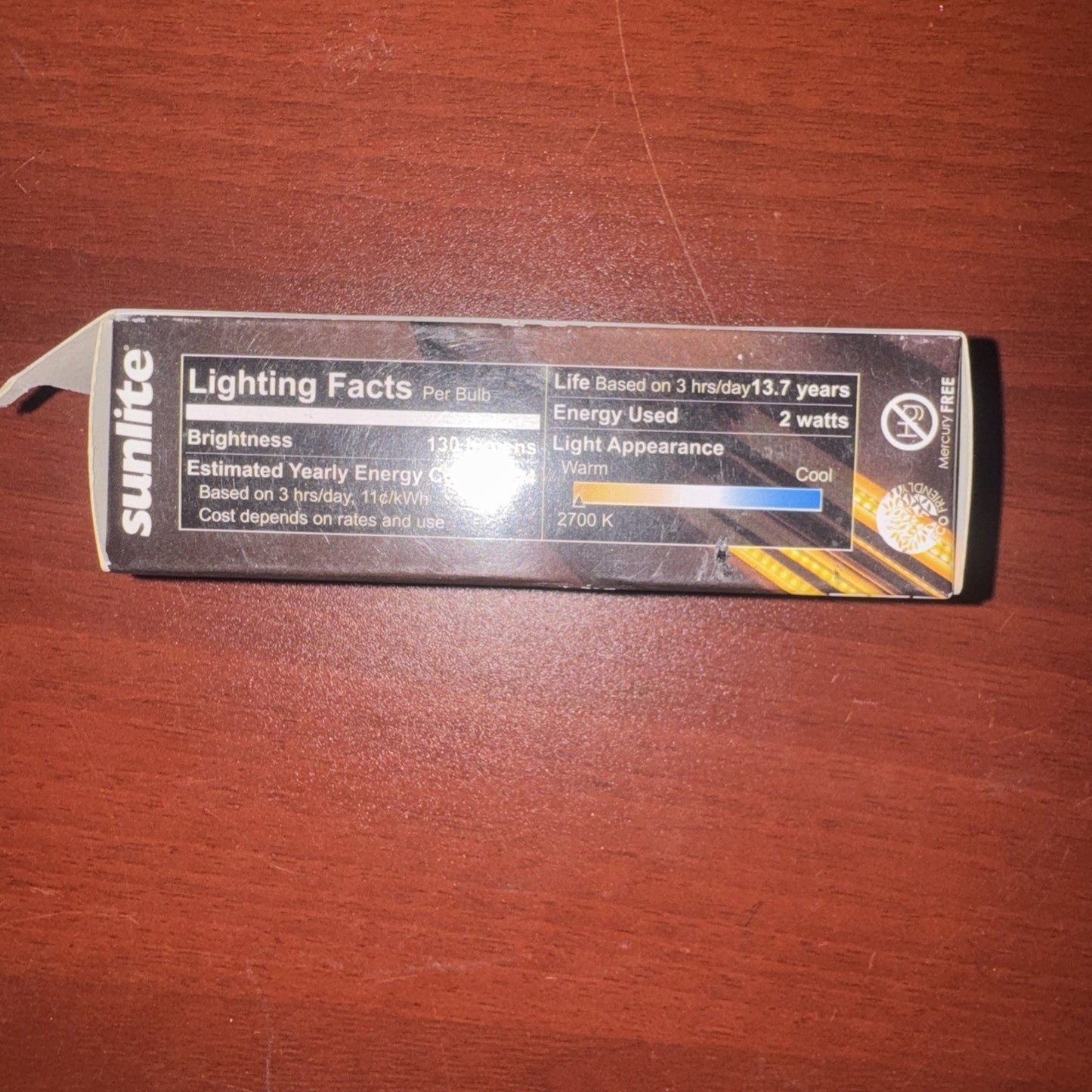 Sunlite T8 bulb packaging showing lighting facts with 130 lumens, 2 watts energy use, and 2700K warm light temperature