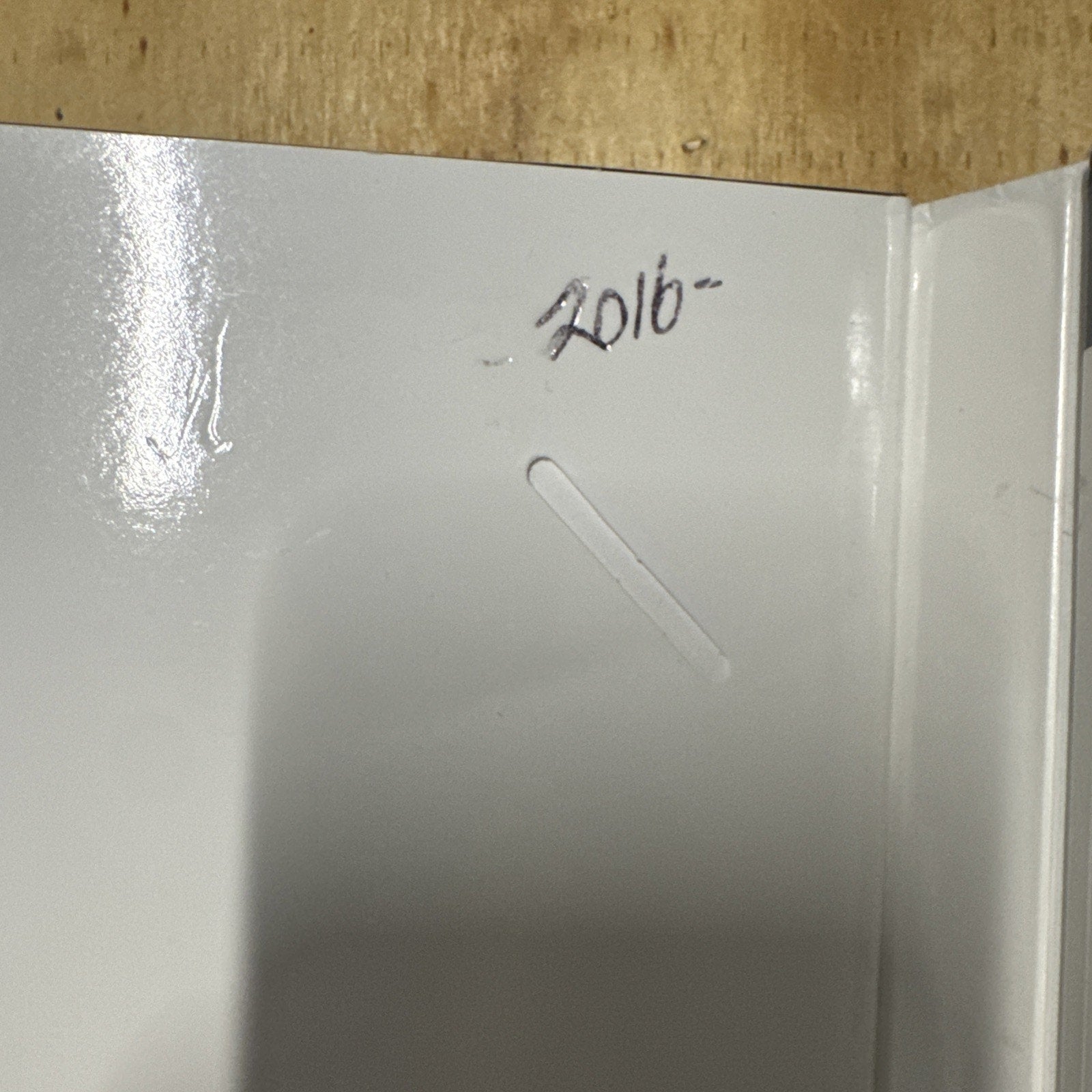 Close-up of inside Goldwell Color Catalog cover showing handwritten year 2016 on white surface